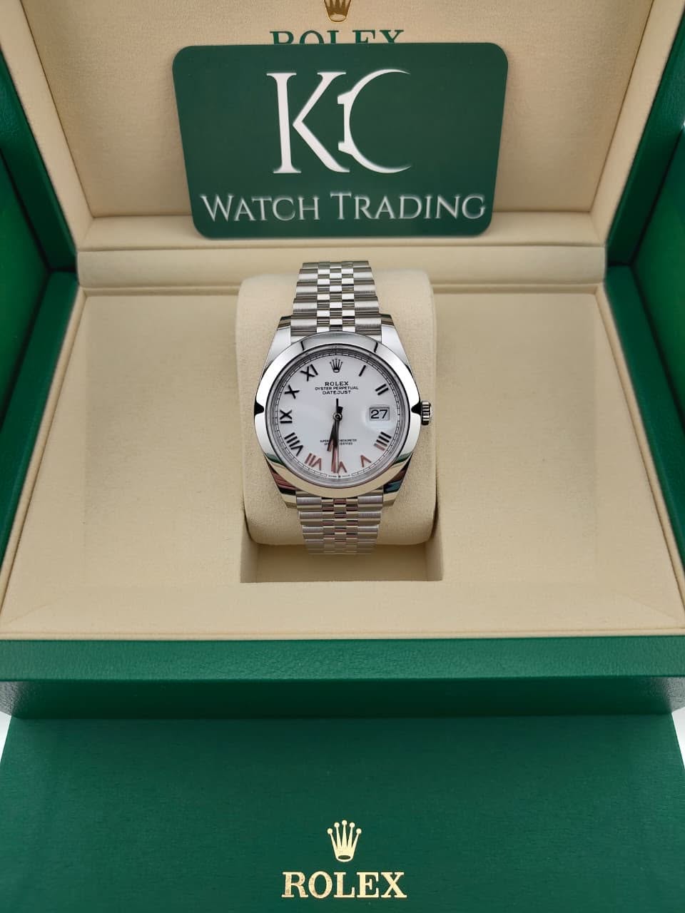 May be an image of wrist watch and text that says 'DOLRV KC WATCHTRADING WATCH TRADING XI ትመ ROLEX 8า HaaL DATE DATEJUE 27 រ IX VIII ViI .ញ) a 0 -" III ه ROLEX'