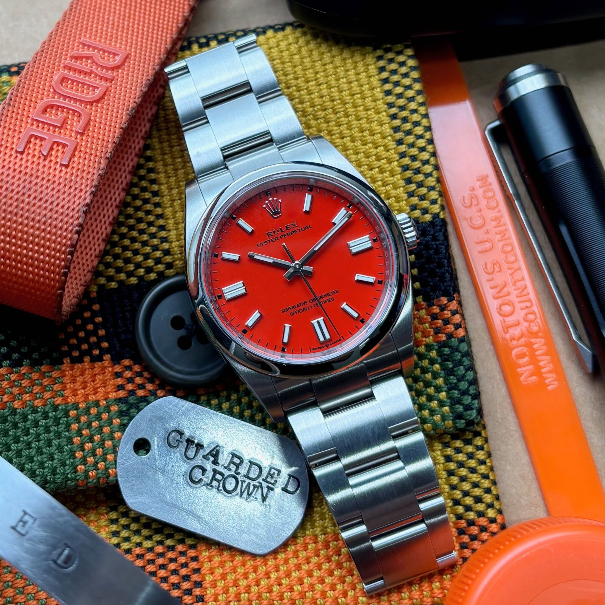 May be an image of knife, wrist watch, lighter and text