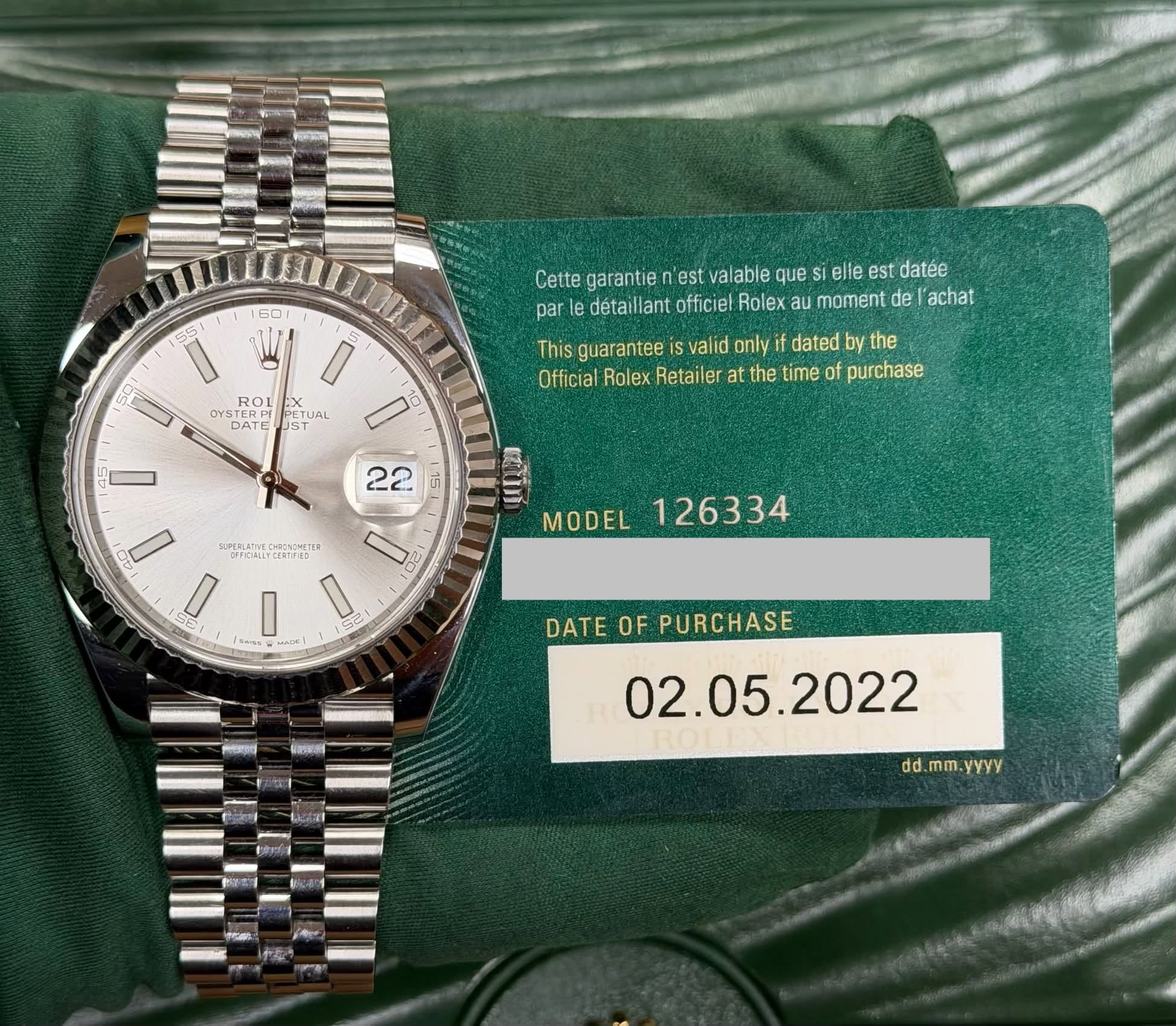 May be an image of wrist watch and text that says '55 60 VI 5 69 Cette garantie est alable que si elle est datée par détaillant officiel Rolex moment de achat OYSTER ្ា DATE…