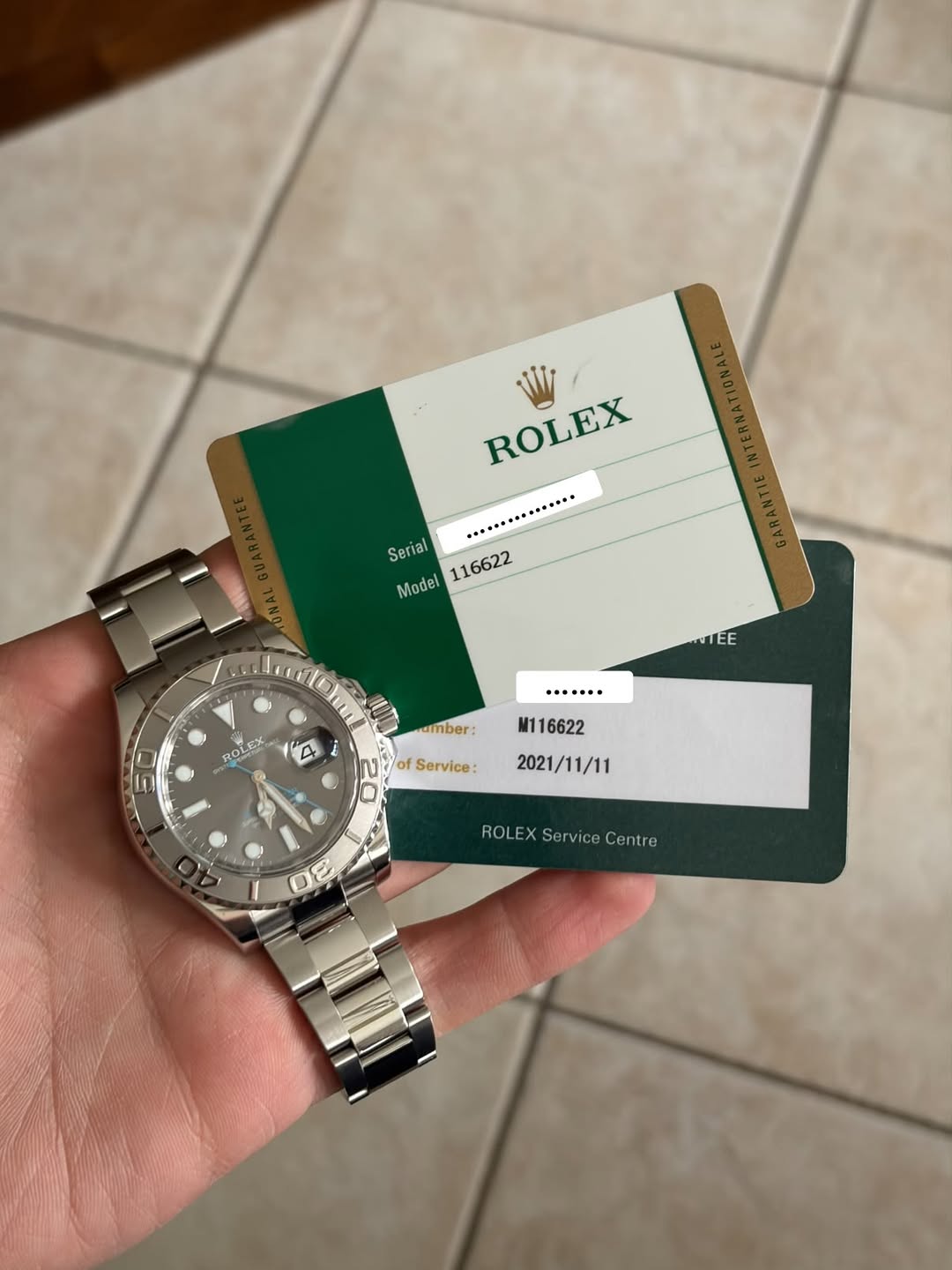 May be an image of money, wrist watch and text that says 'ROLEX Serial 116622 Model TEE ·.····… ROLES OLEX amber: A i M1 116622 of Service: D 2021/11/11 ROLEX X ROLEXServiceCentre…