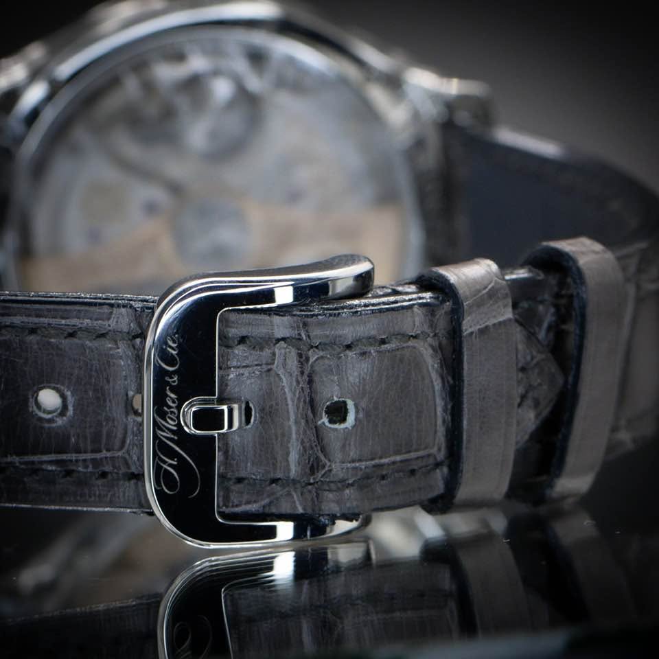 May be an image of saddle-stitched leather, leather, wrist watch and text