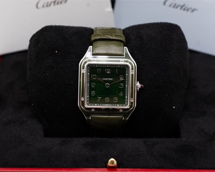 May be an image of wrist watch and text that says 'Cartier CARTIER'