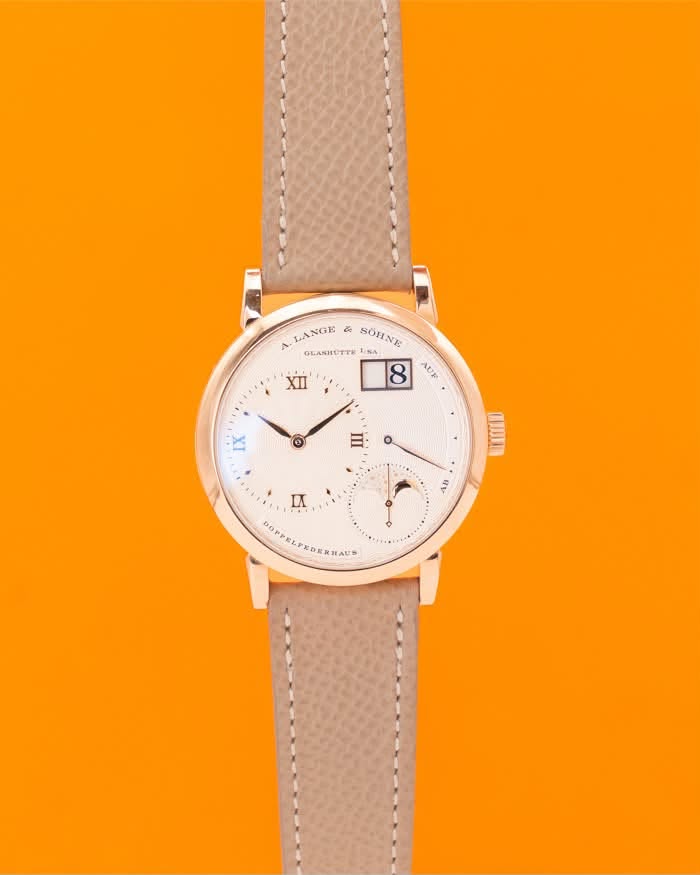 May be an image of leather, wrist watch and text