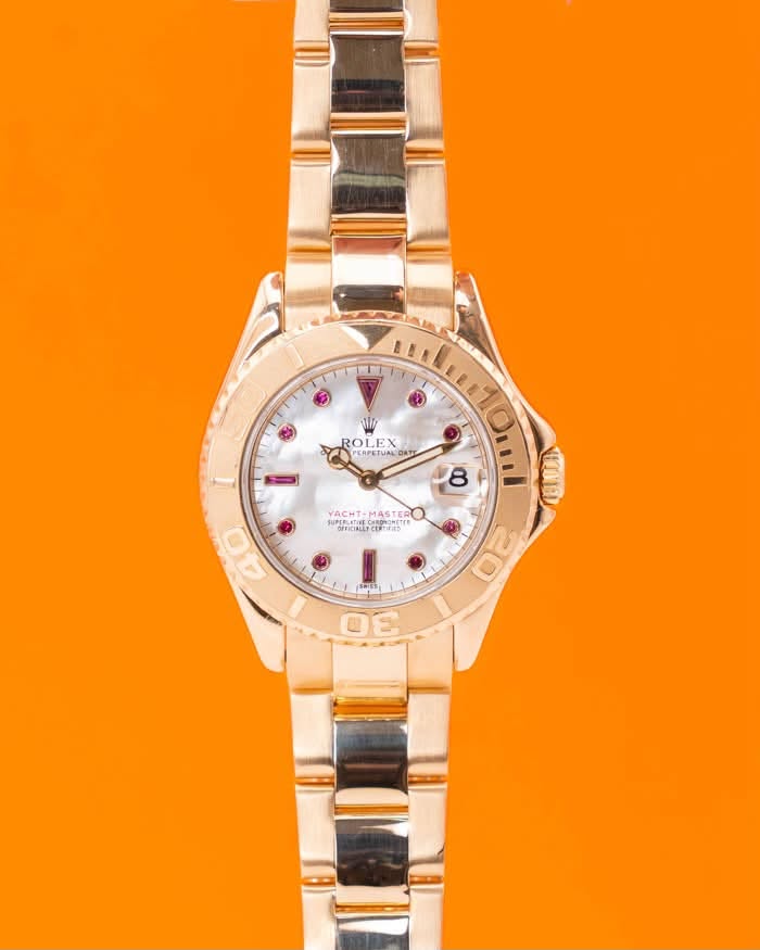 May be an image of jewelry, wrist watch and text