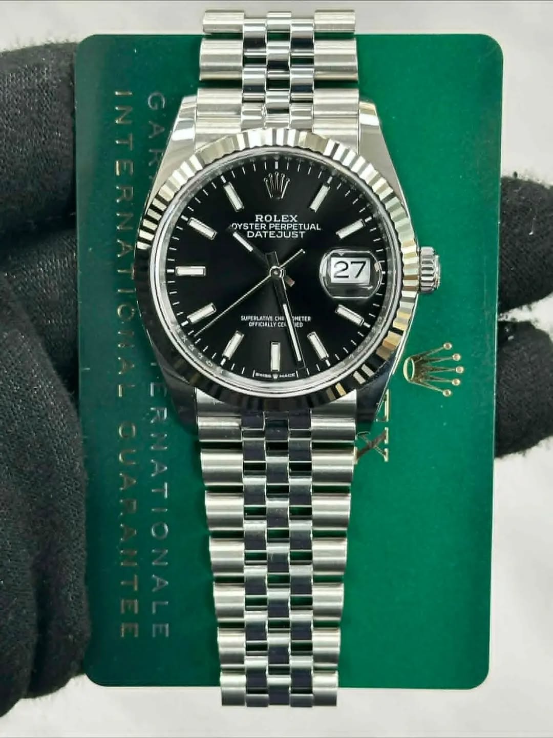 May be an image of wrist watch and text that says 'ROLEX OYS DATEJUST PERPETUAL TUAL DATE TEJUST DAT 27 SUPERLATIVS o OFFICIALL e ពេញ ETER ED 0 1 Seas MIE I'