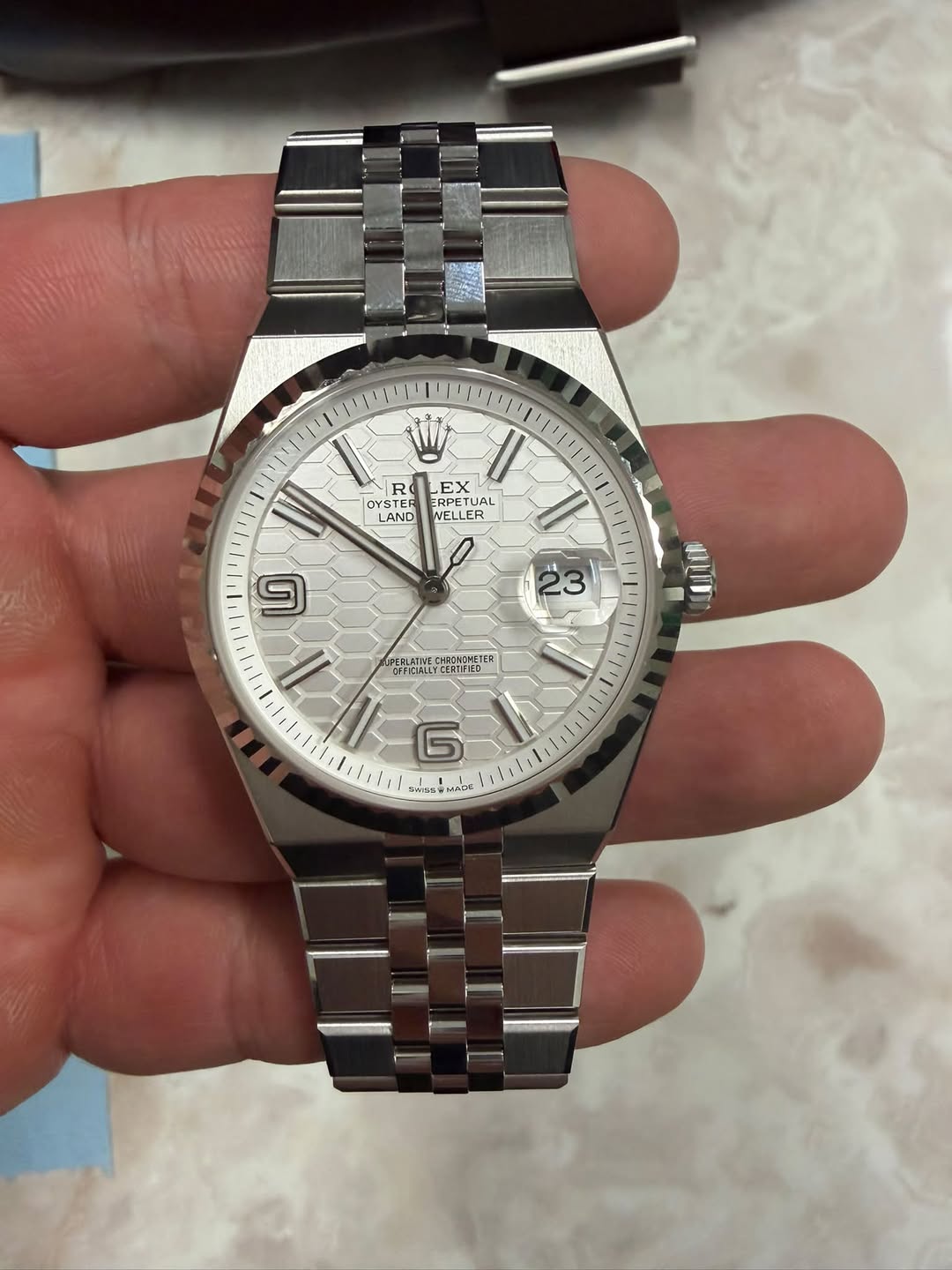 May be an image of wrist watch and text