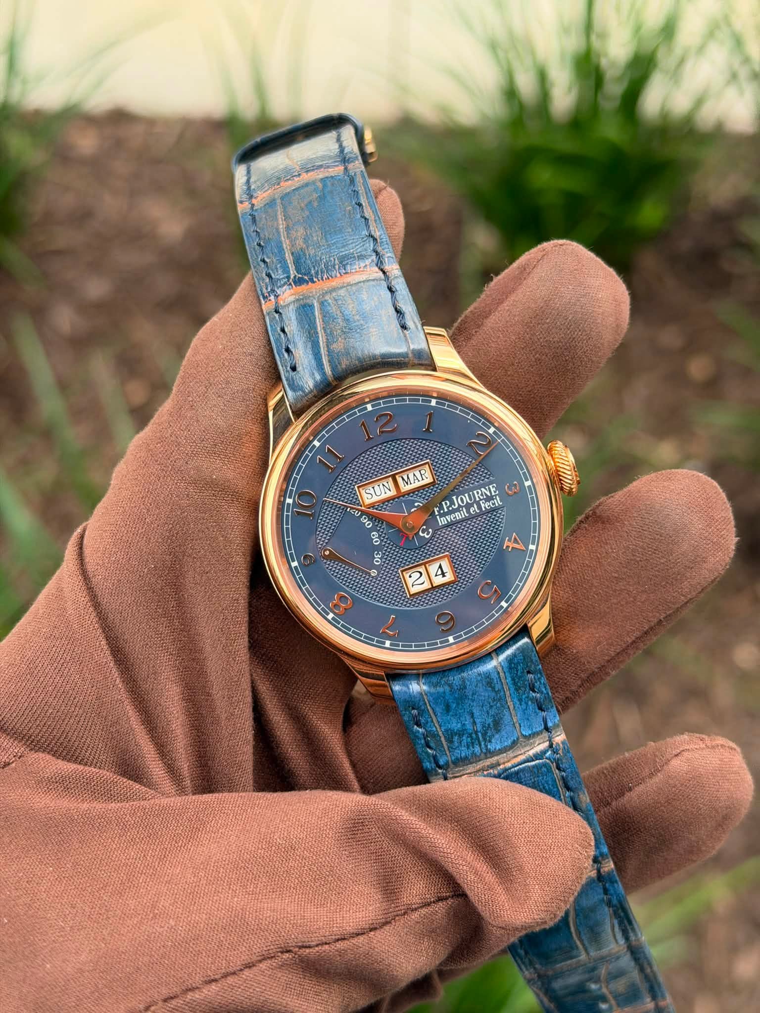May be an image of leather, wrist watch and text that says '11 SUN MAR ن Invenit .PJOURNE URNE Fecil 3 0 0 A 2 4'