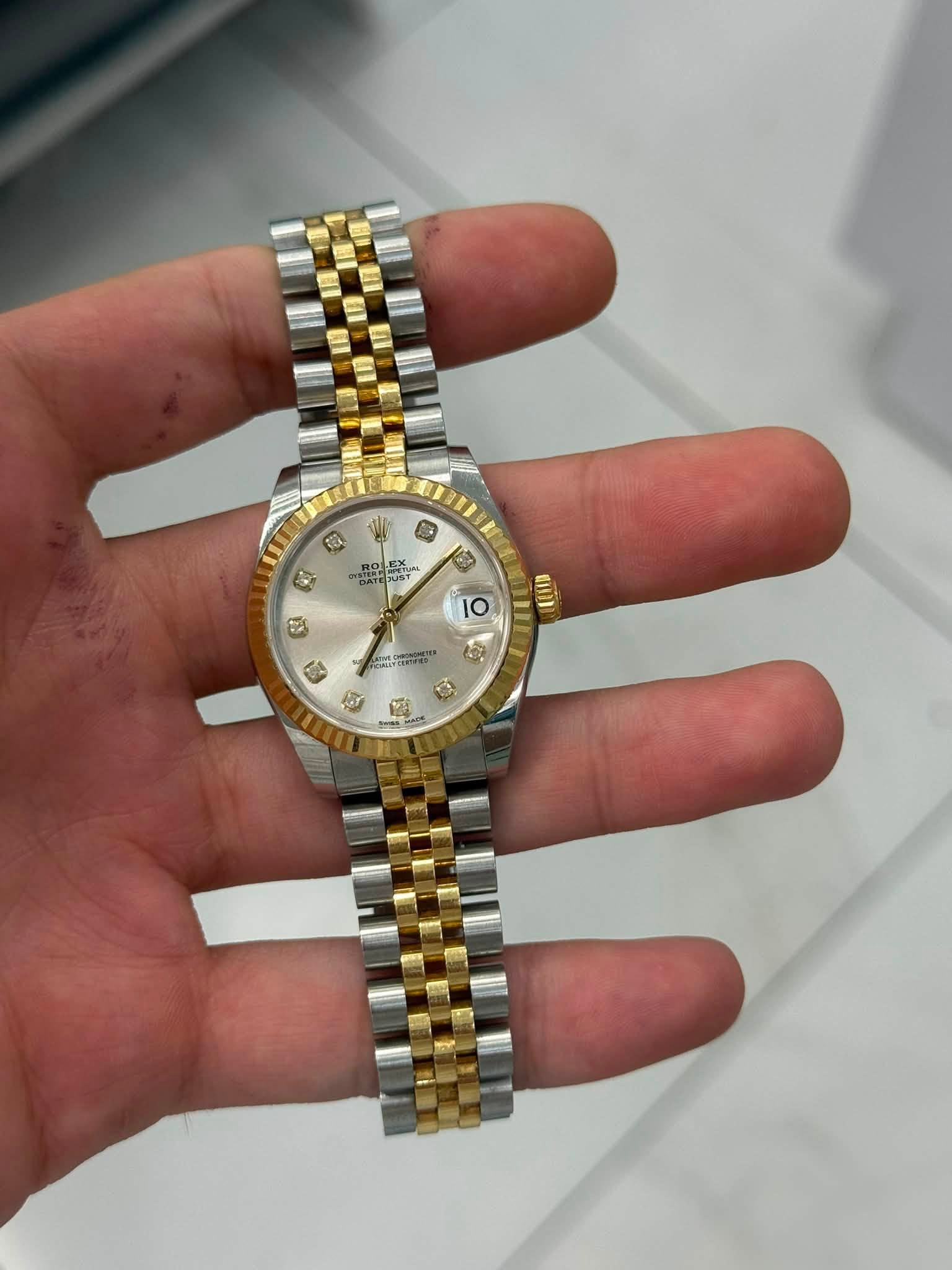 May be an image of wrist watch and text
