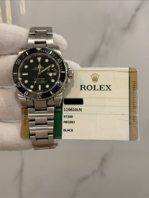 May be an image of wrist watch and text that says 'ROLEX 116610LN 97200 NEGRO BLACK'