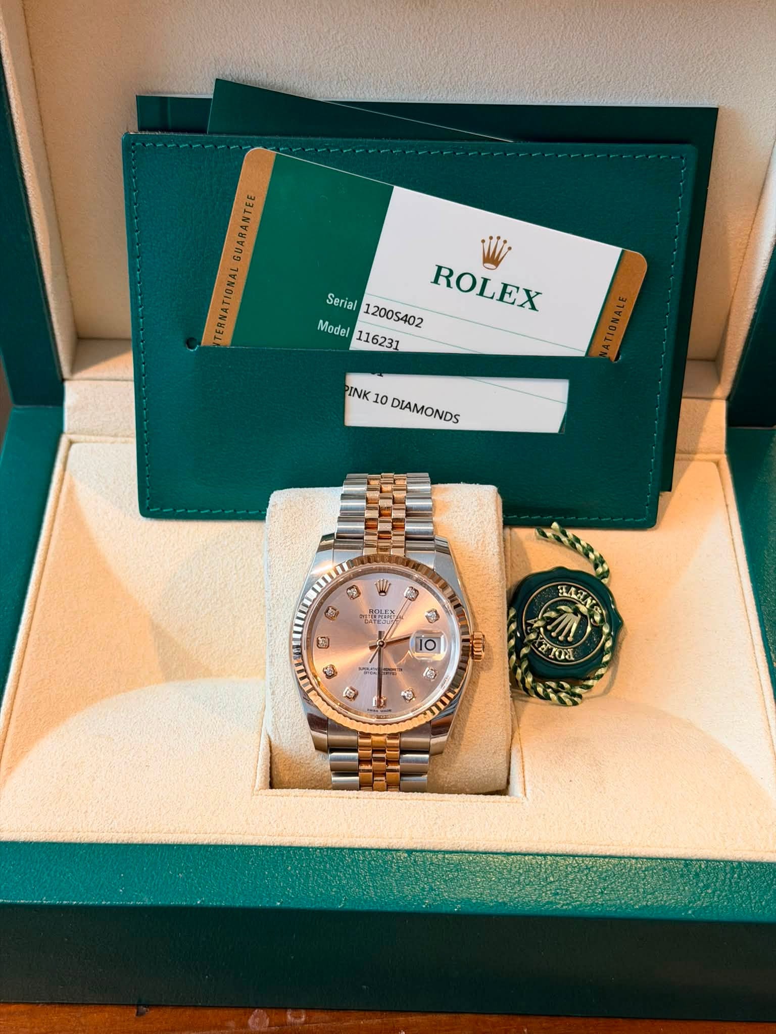 May be an image of wrist watch and text that says 'GUARANTEE TERNATIONAL Model Serial12005402 Seria Model116231 12005402 ROLEX 116231 PINK 10 DIAMONDS DIAMONDS W 1 1 所 10 25 Jinr…