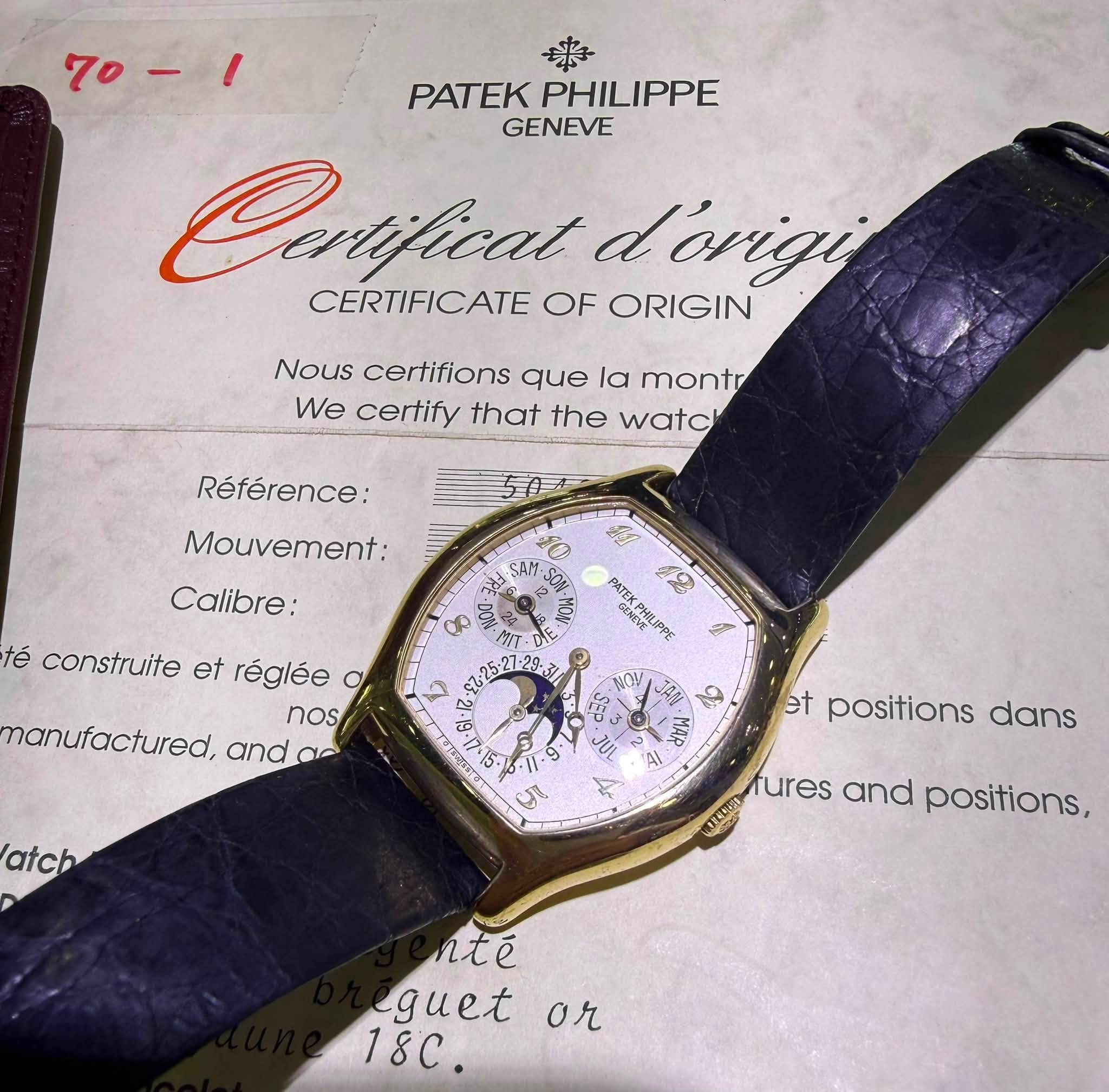 May be an image of digital watch and text that says '70-1 PATEK PHILIPPE GENEVE Corfical dorigi CERTIFICATE OF ORIGIN Nous certifions que la montr We certify that the watc…