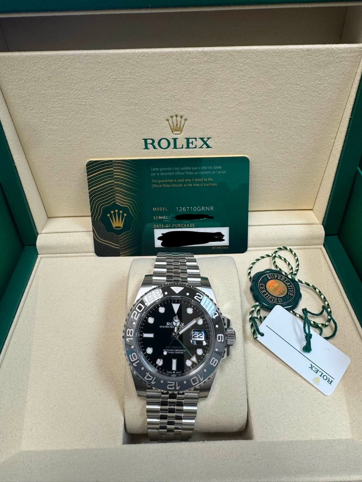 May be an image of wrist watch and text that says 'ROLEX 126710GRNR ዋፕ RN 2 14 RO P の 80 XITOX'