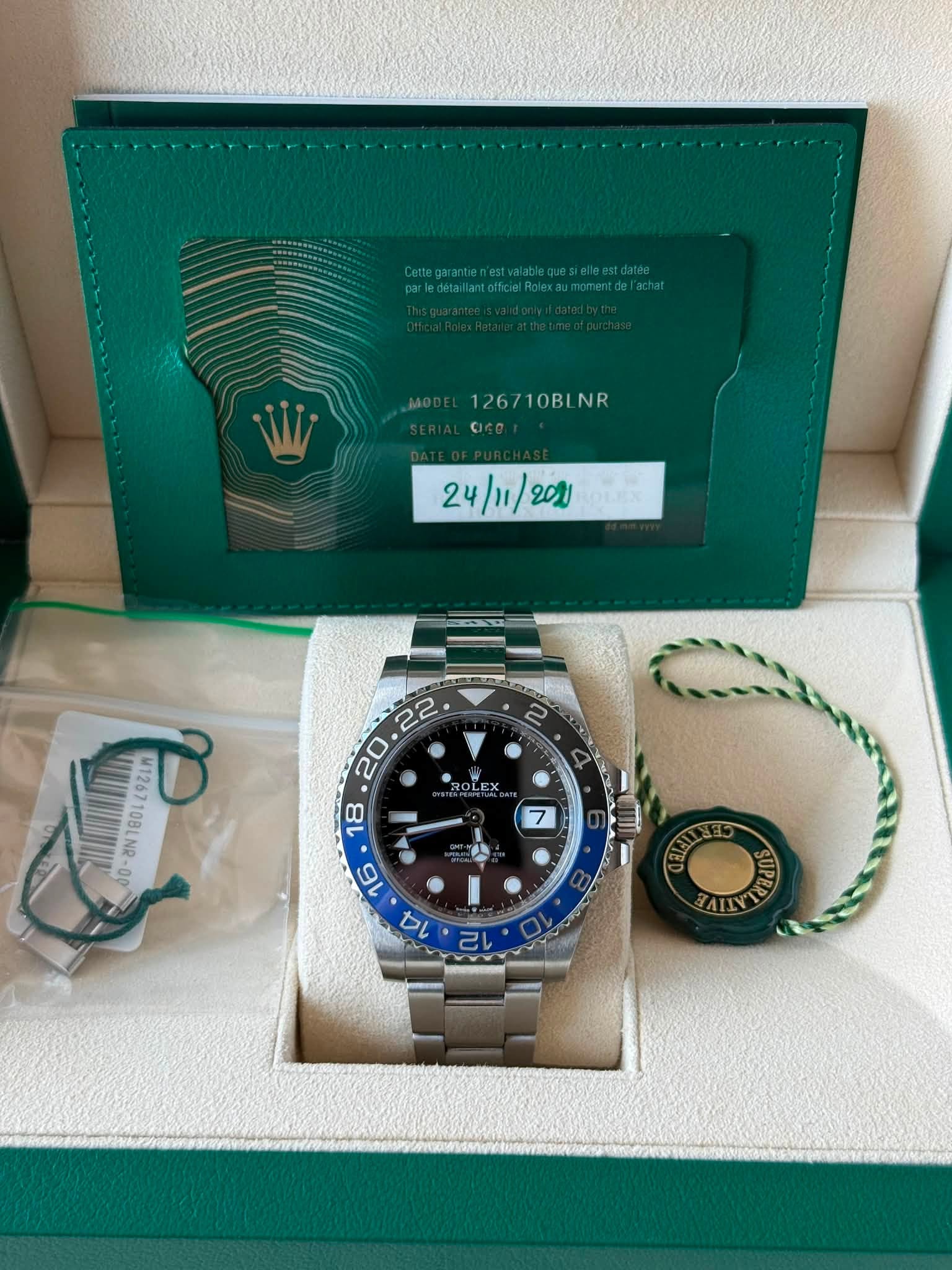 May be an image of wrist watch and text that says '1267 126710BLNR NR 24/11/ M1267 P 108 0E M126710BLNR-00 10 LNG SdUs AIY 12 己い'