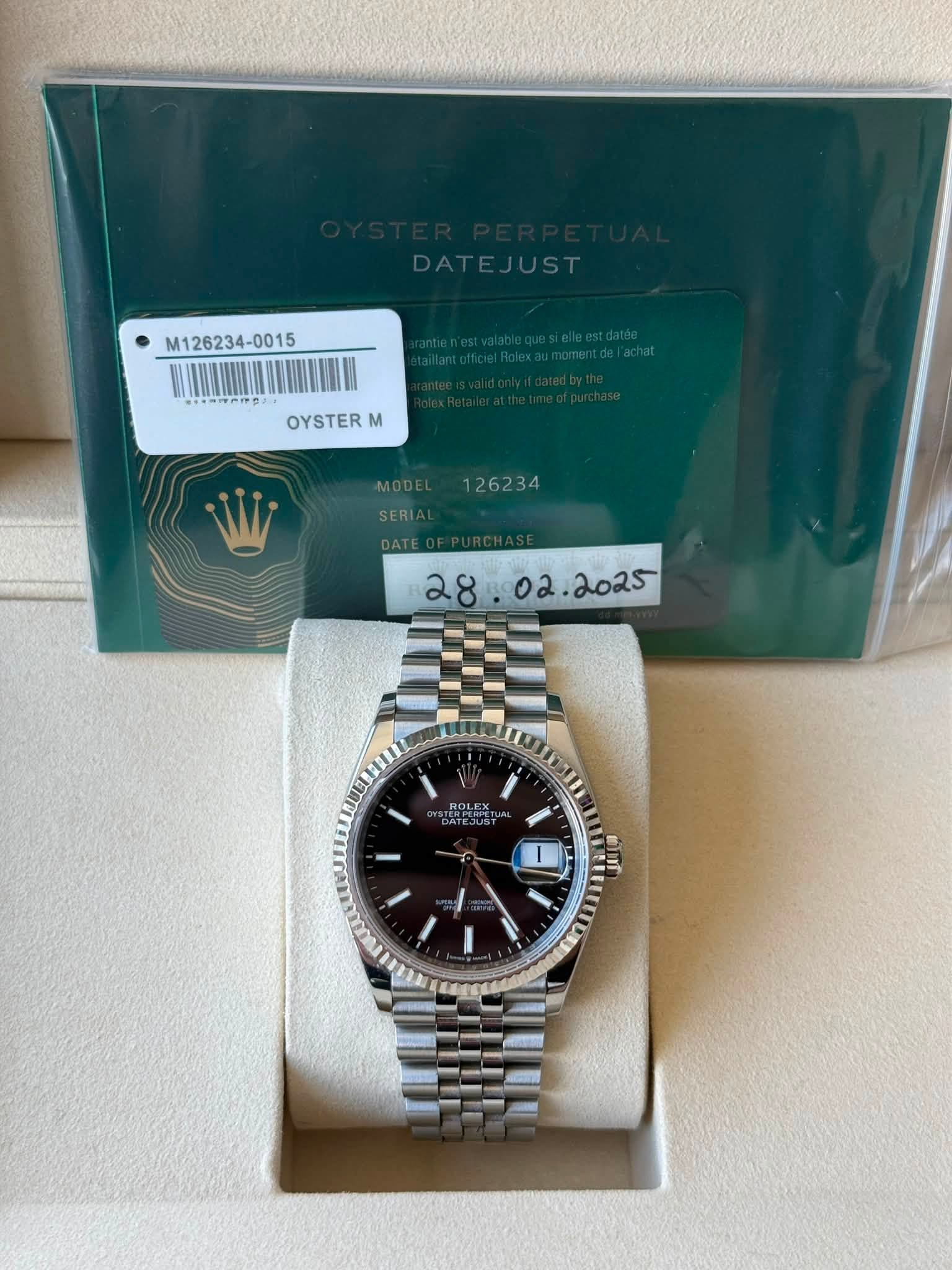May be an image of wrist watch and text that says 'M126234-0015 OYSTERM M MODE 126234 SERI DATE ROLEX الل O'