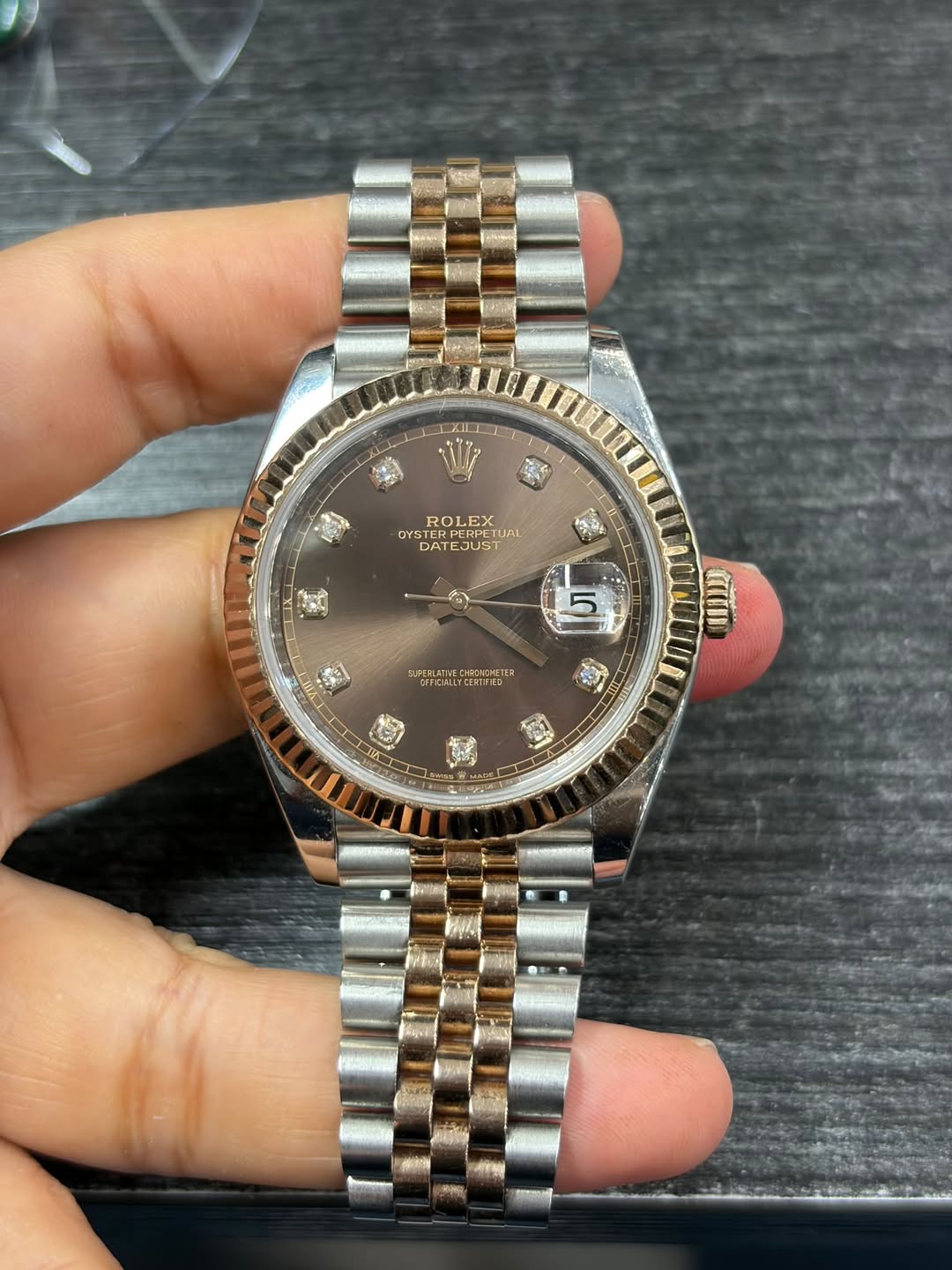 May be an image of wrist watch and text