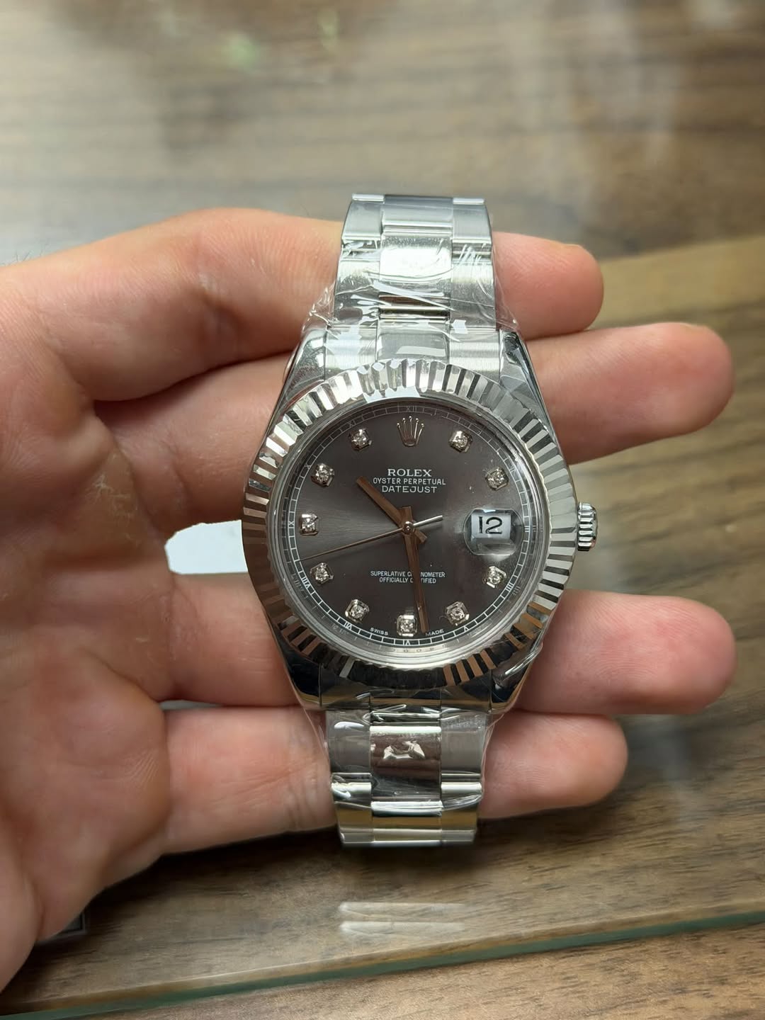 May be an image of wrist watch and text
