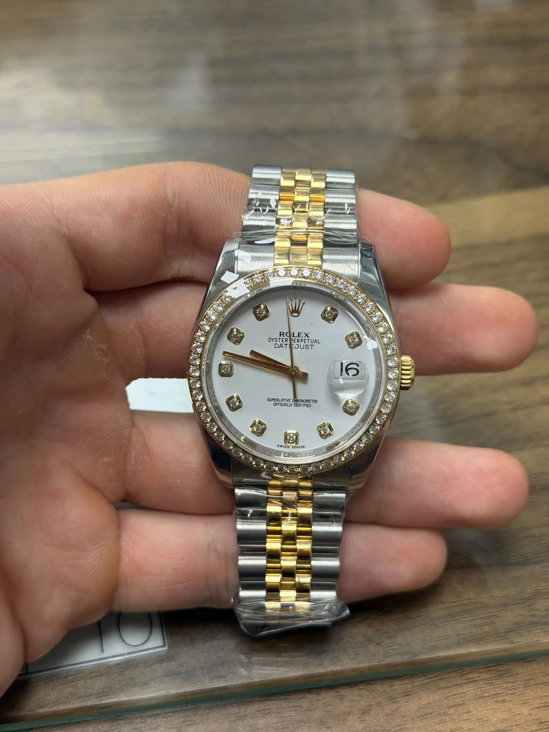 May be an image of wrist watch and text