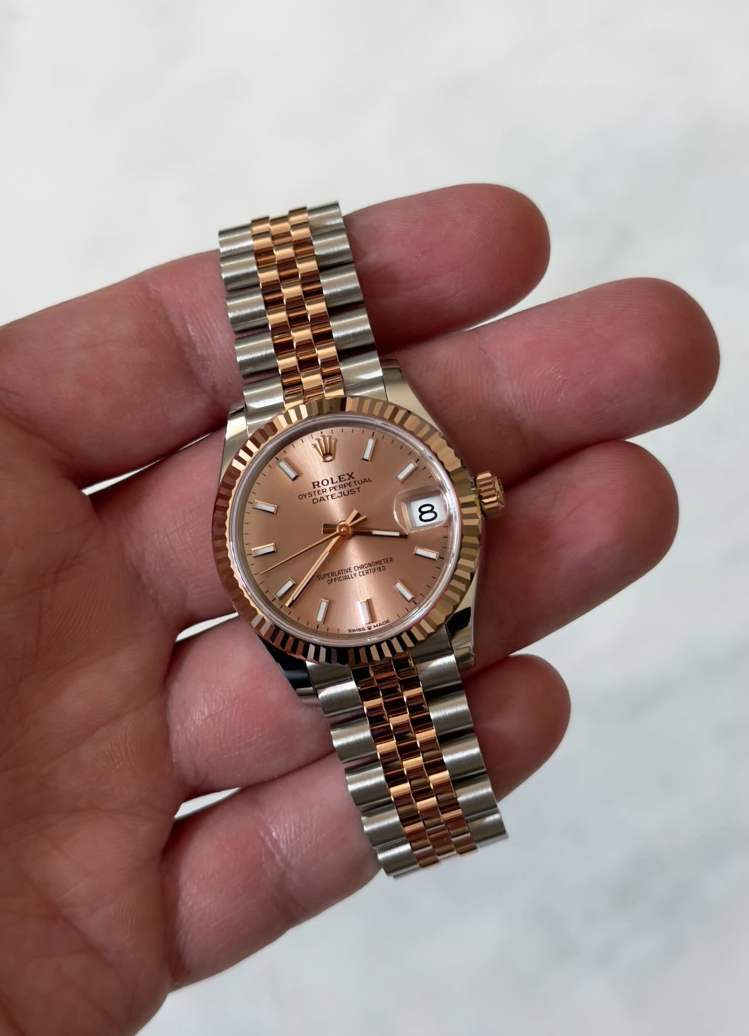 May be an image of wrist watch and text