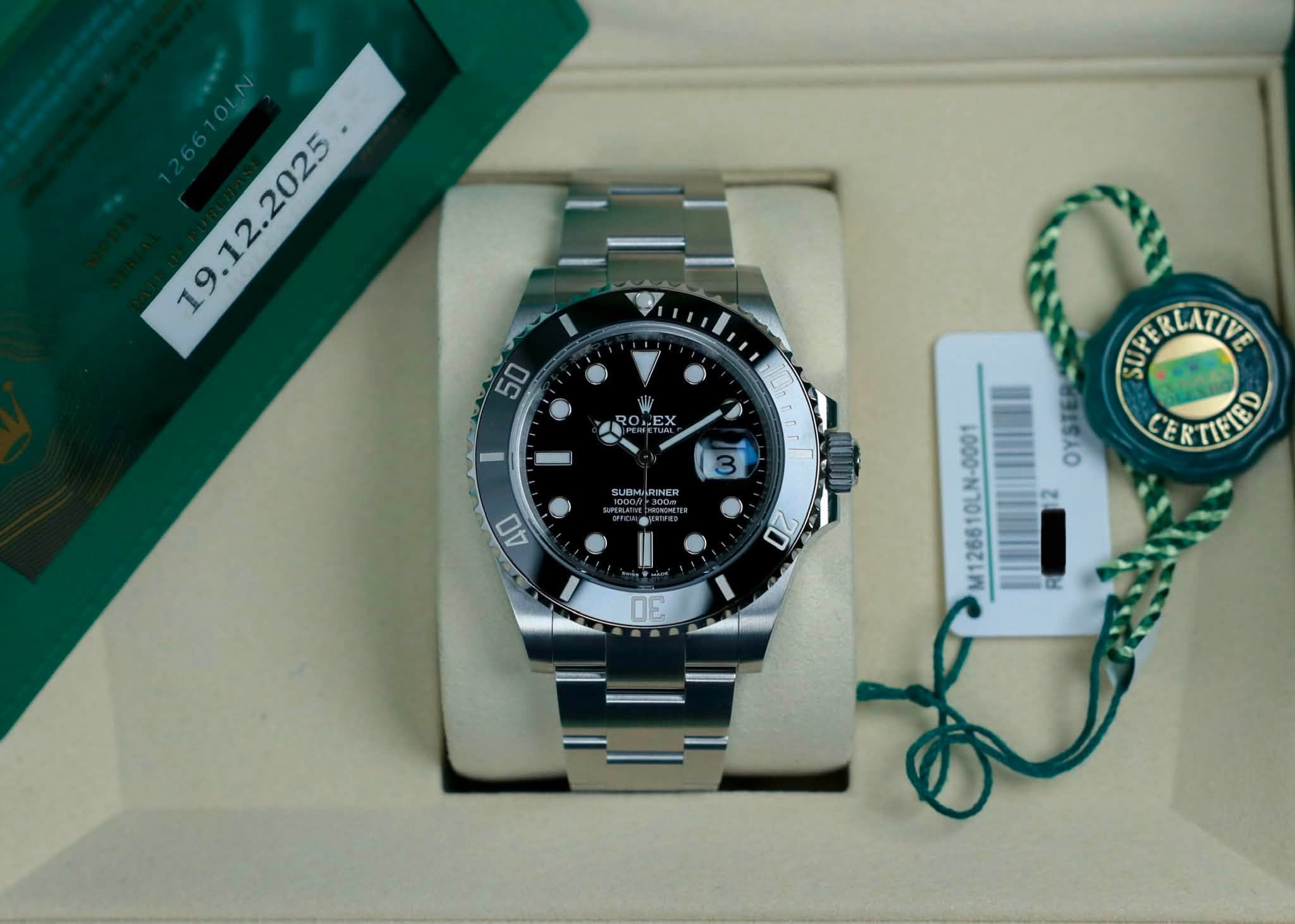 May be an image of wrist watch and text that says ' ROLEX I UBMRINER SUPE STRERLATINE LATIVE CERTIEED 40 3 OZ 0E M126610LN-0001'