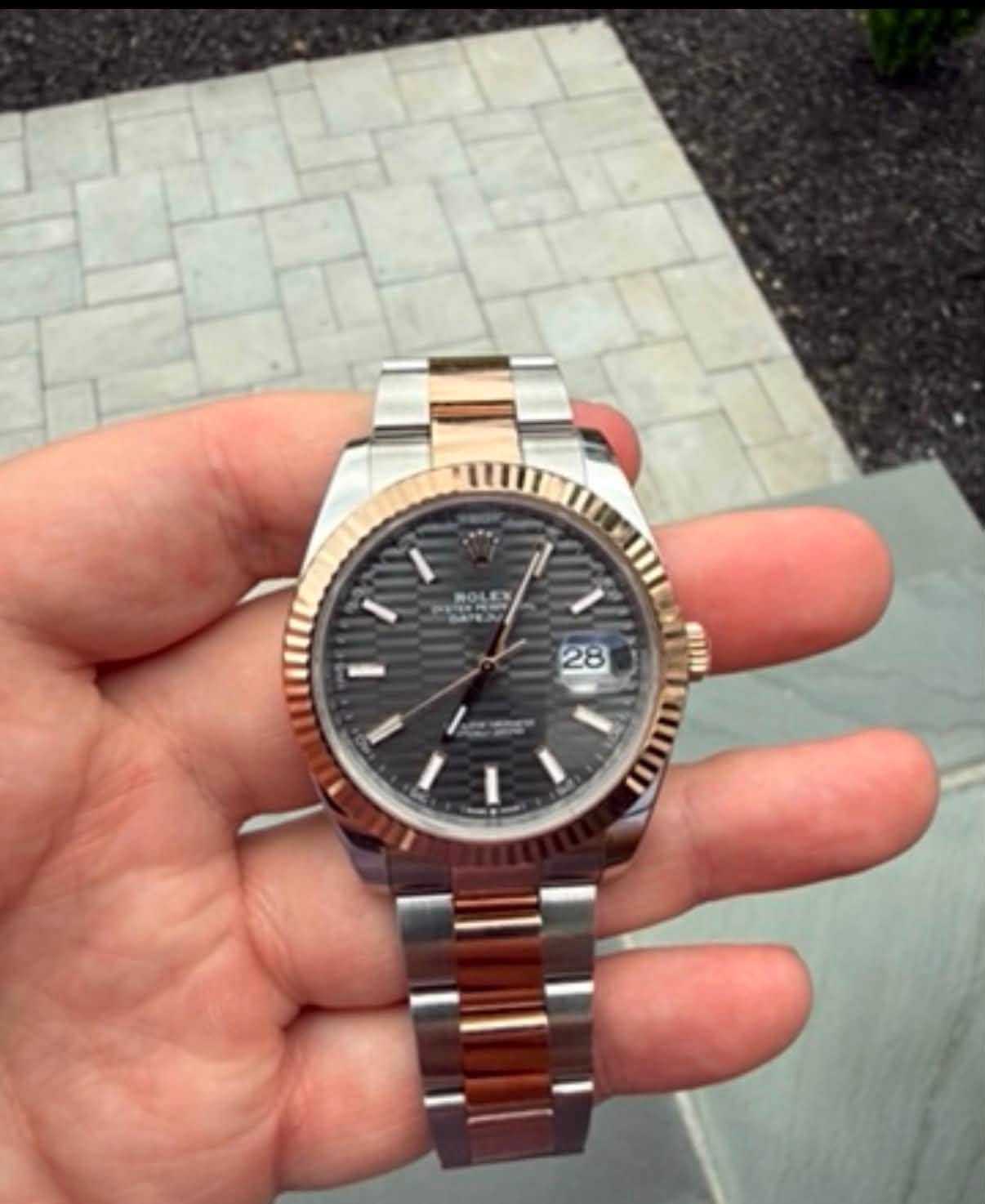 May be an image of wrist watch and text