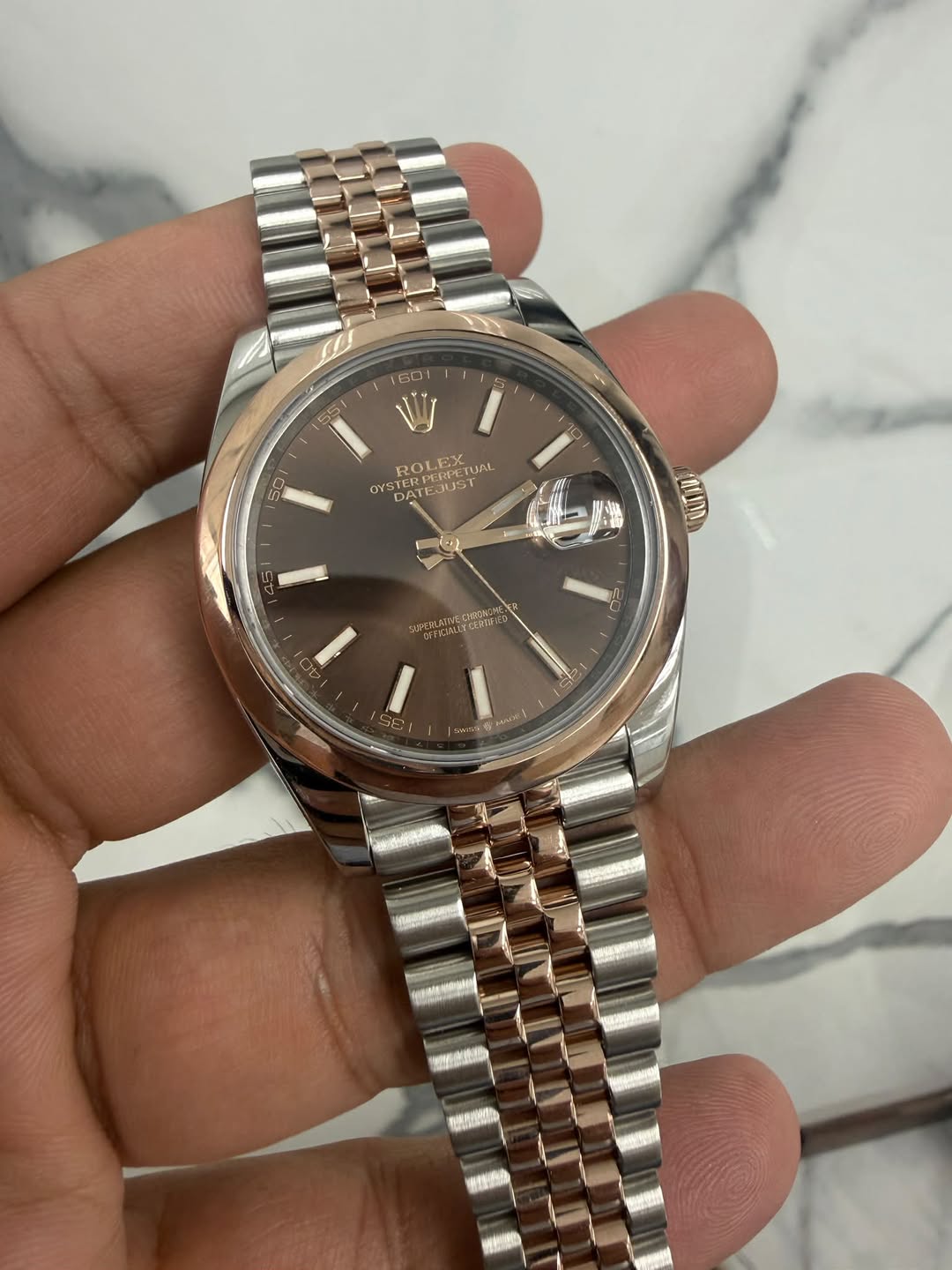 May be an image of wrist watch and text