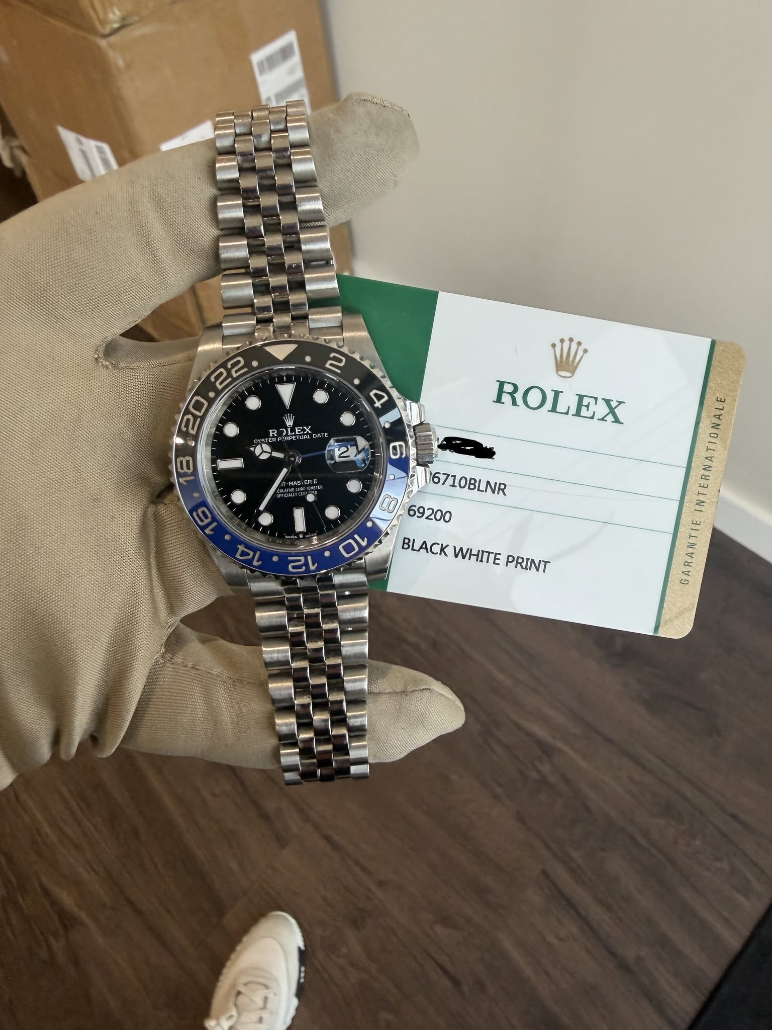 May be an image of wrist watch and text that says '2 22 20. ម្នឡអរូ 8 Q ROLEX 6710BLNR 69200 BLACK BLACKWHITE WHITE PRINT INTERNATIONALE GARANTIE'