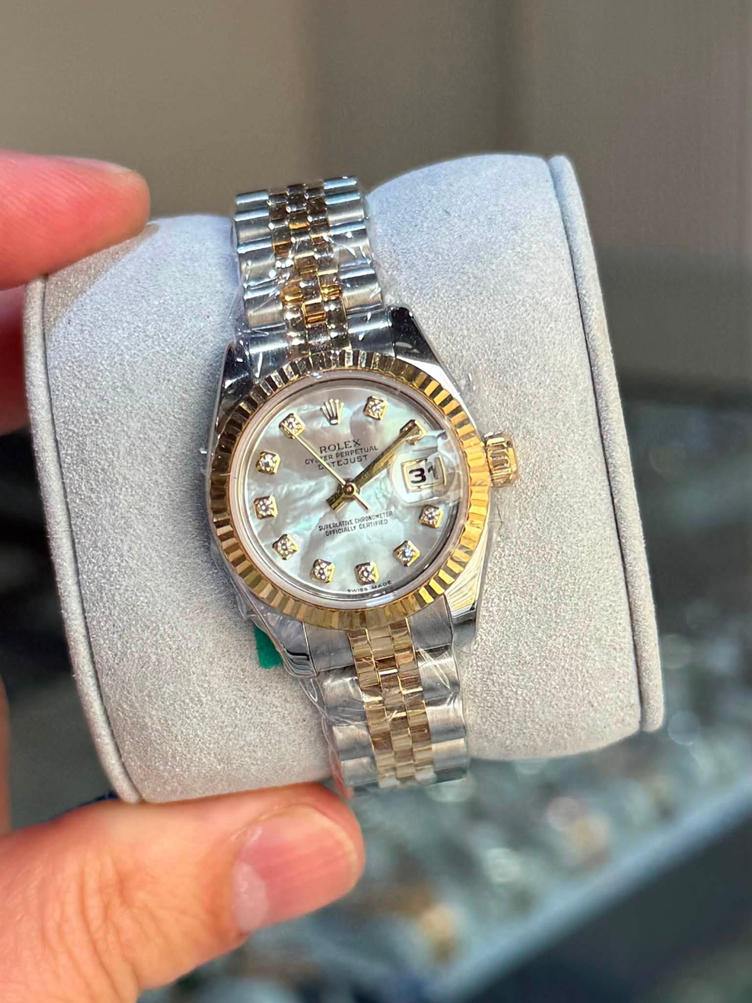 May be an image of wrist watch and text