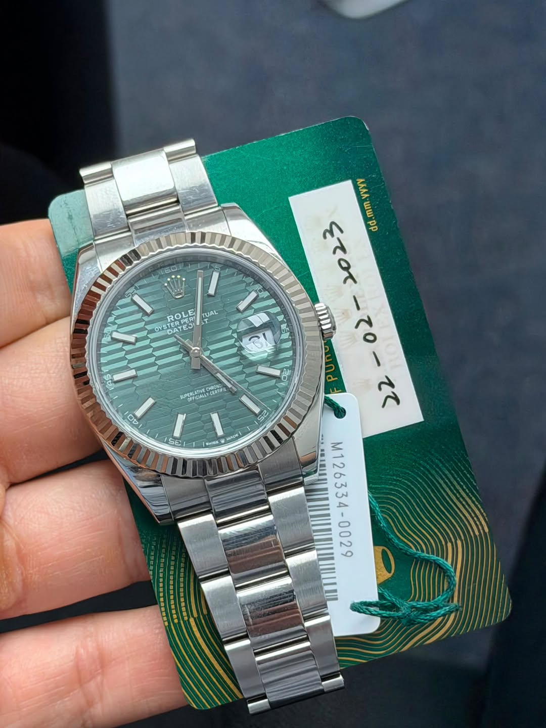 May be an image of wrist watch and text