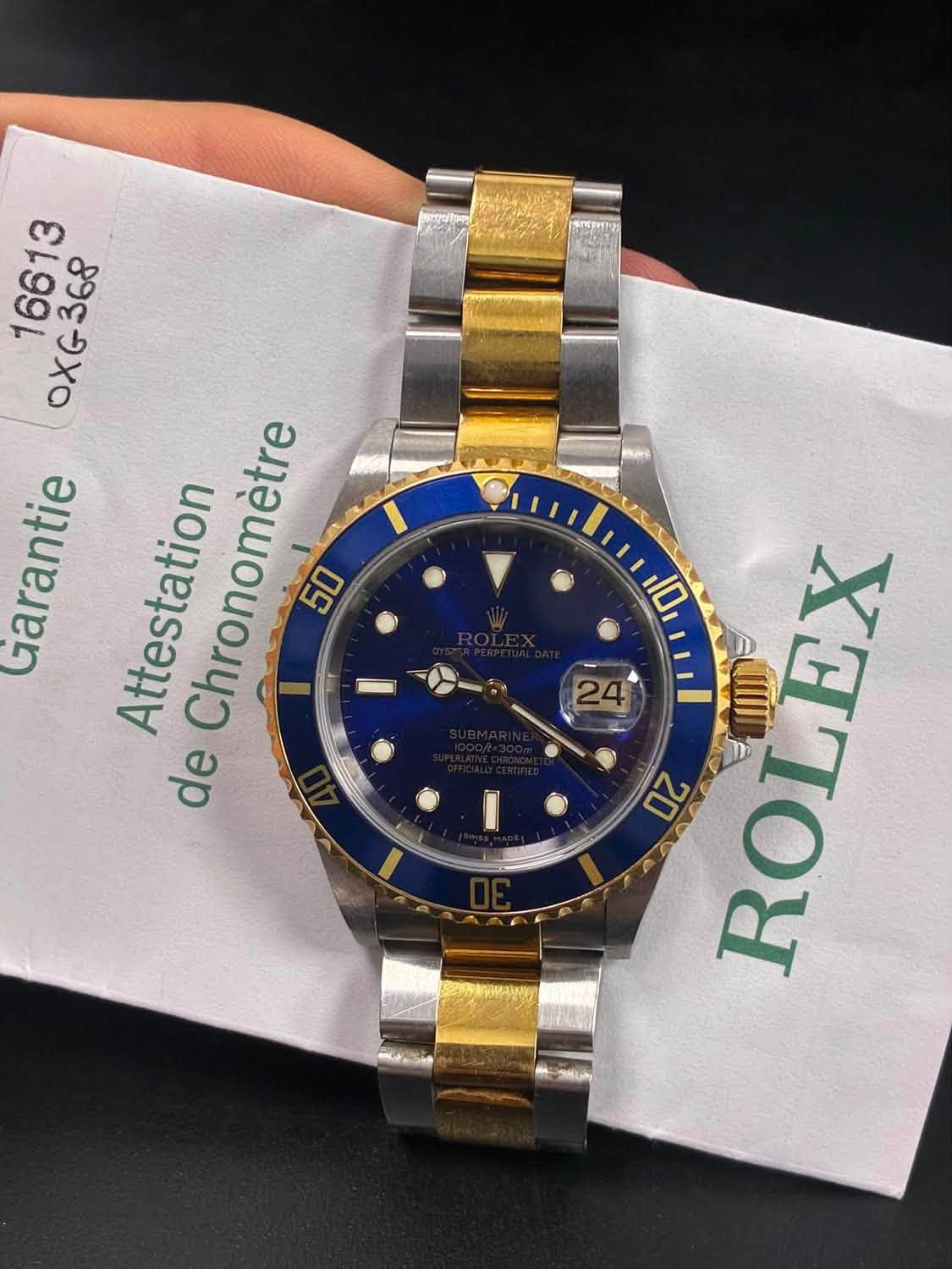 May be an image of wrist watch and text that says '16613 OXG368 368 OXG Garantie Attestation Chronomètre 50 de ROLEX'