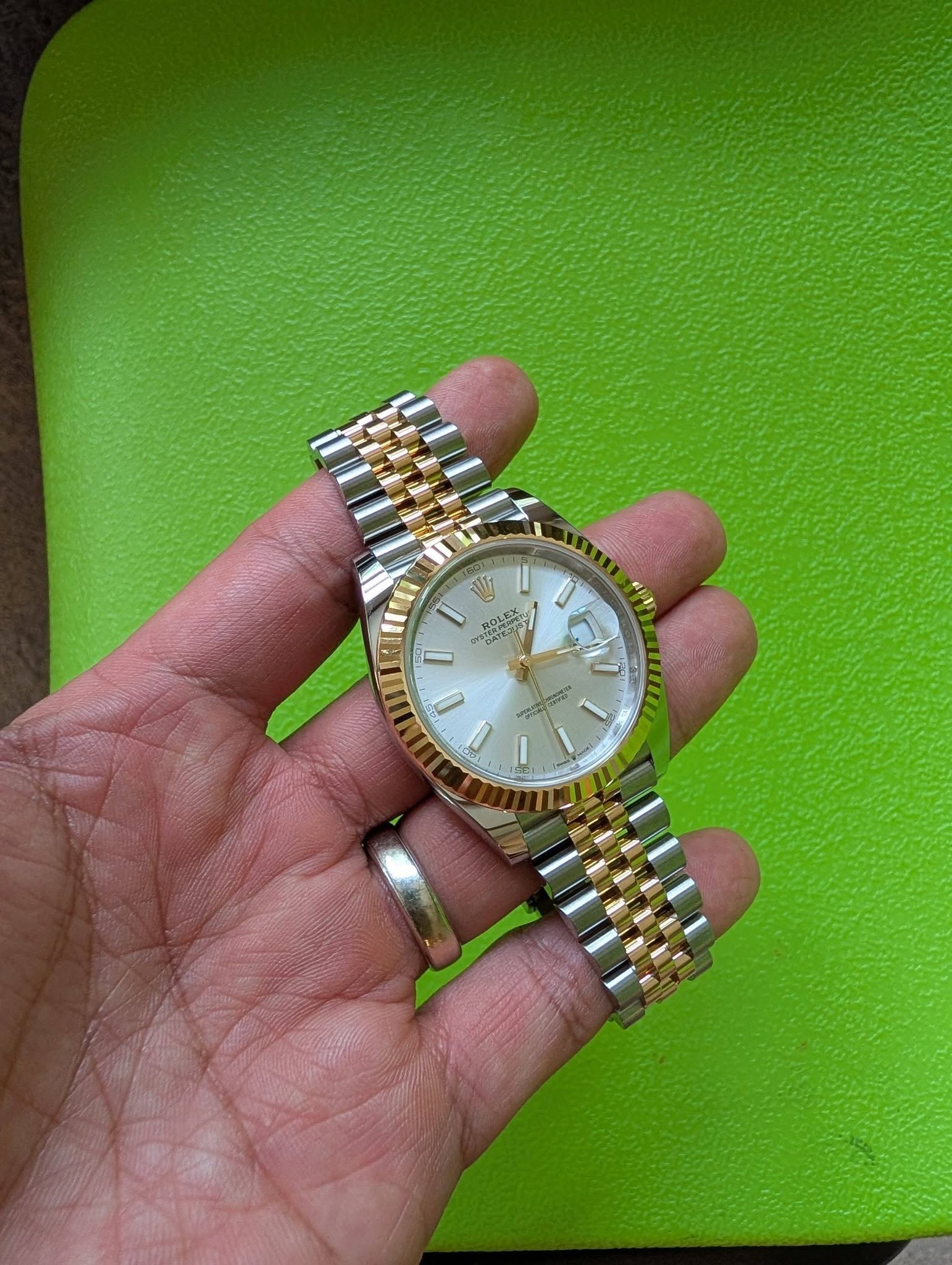 May be an image of wrist watch and text