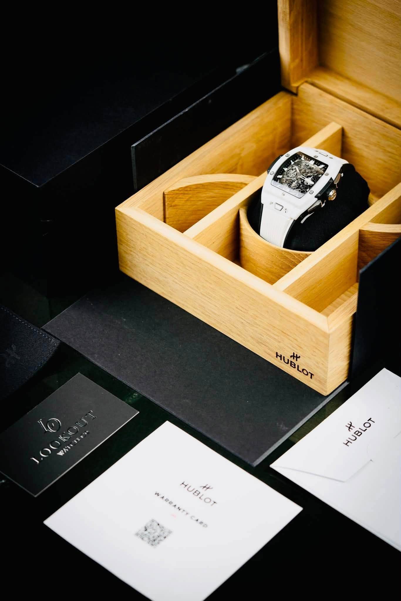May be an image of digital watch and text that says '9 : HUBLOT HUBI そ HUBLOT LOT WAN WAT HUBLOT JUBLOT א WABBANTYCARD W WARDANTY HUBLOT ٣ жлp'