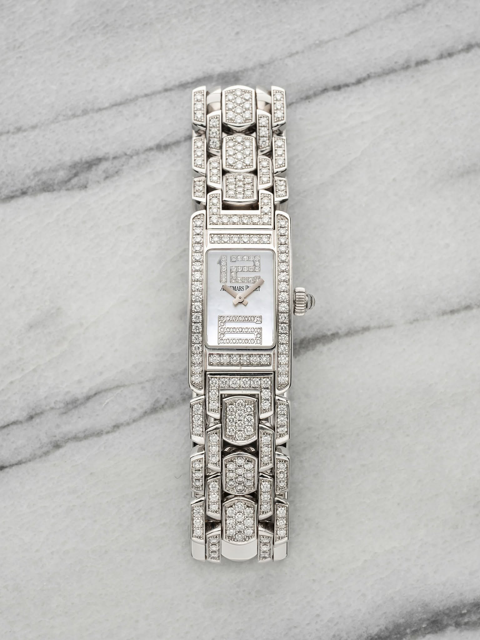 May be an image of jewelry, wrist watch and text
