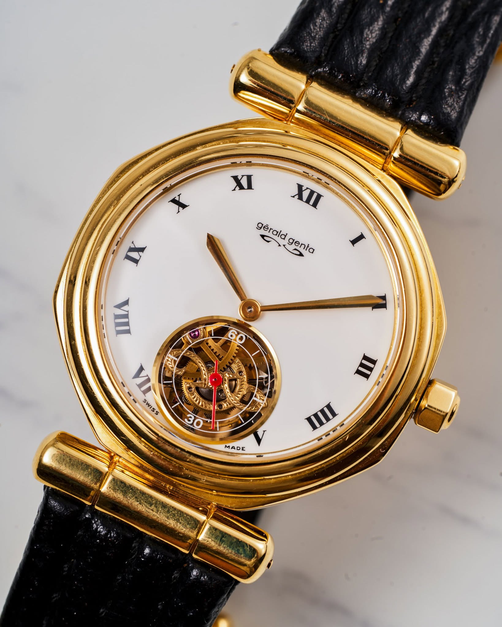 May be an image of wrist watch and text that says 'XI X XII gerald C 3 genta IX I WΑ 4ی - E & 4 ह a LI 2 עבי 10 T NE IC ወ ከራላ مح I SWISS Se 3 MADE III'