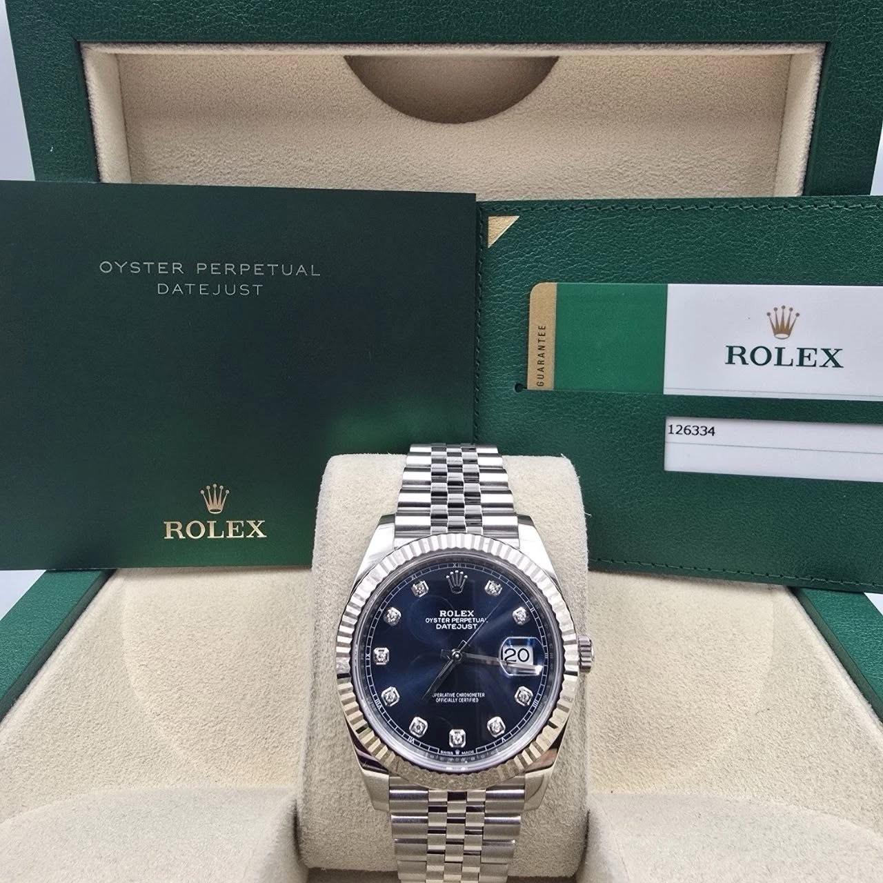 May be an image of wrist watch and text that says 'OYSTERPERPETUAL OYSTE PERPETUAL DATEJUST UST GUARANTLE ROLEX 126334 ROLEX ቁን 瘦 传 STEEPETE QATE-UST 阿 20 O সআতा 用 III D C 国'