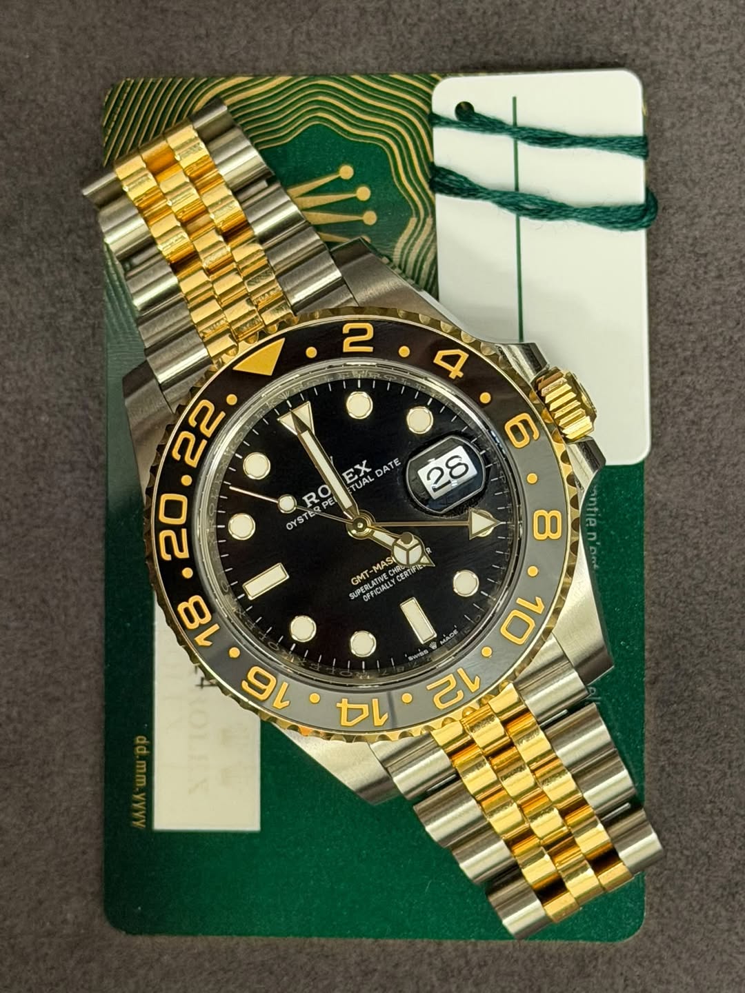 May be an image of wrist watch and text that says ' EX אם TUAL DA ATE RO PEI OYS YSTE I antie MASI HRS CERTIF GMT OPFICIALLY S 10 MADE ူ TSE 12 14'