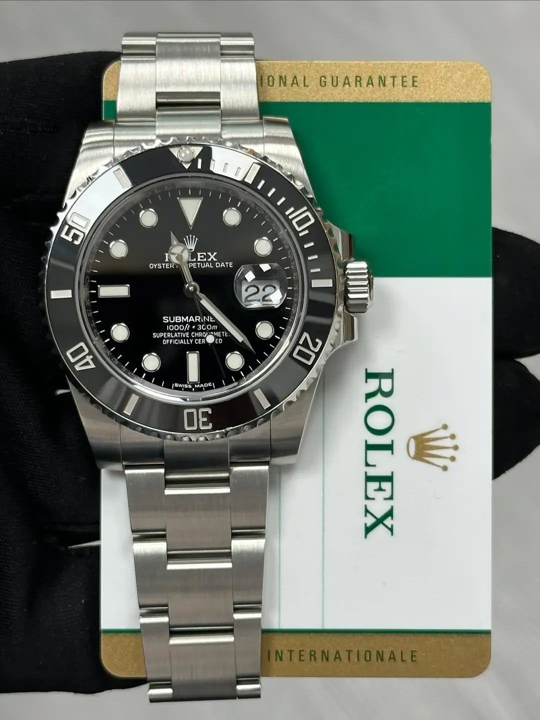 May be an image of wrist watch and text that says 'ONAL GUARANTEE 一家バ~ 50 OYSTERT 10 EX ETUAL DATE 22 SUBMARINE INE 1000A 1000/ 1000/= SUPERL ea รอซ ا =3C0 COm CHRO GFFICA…