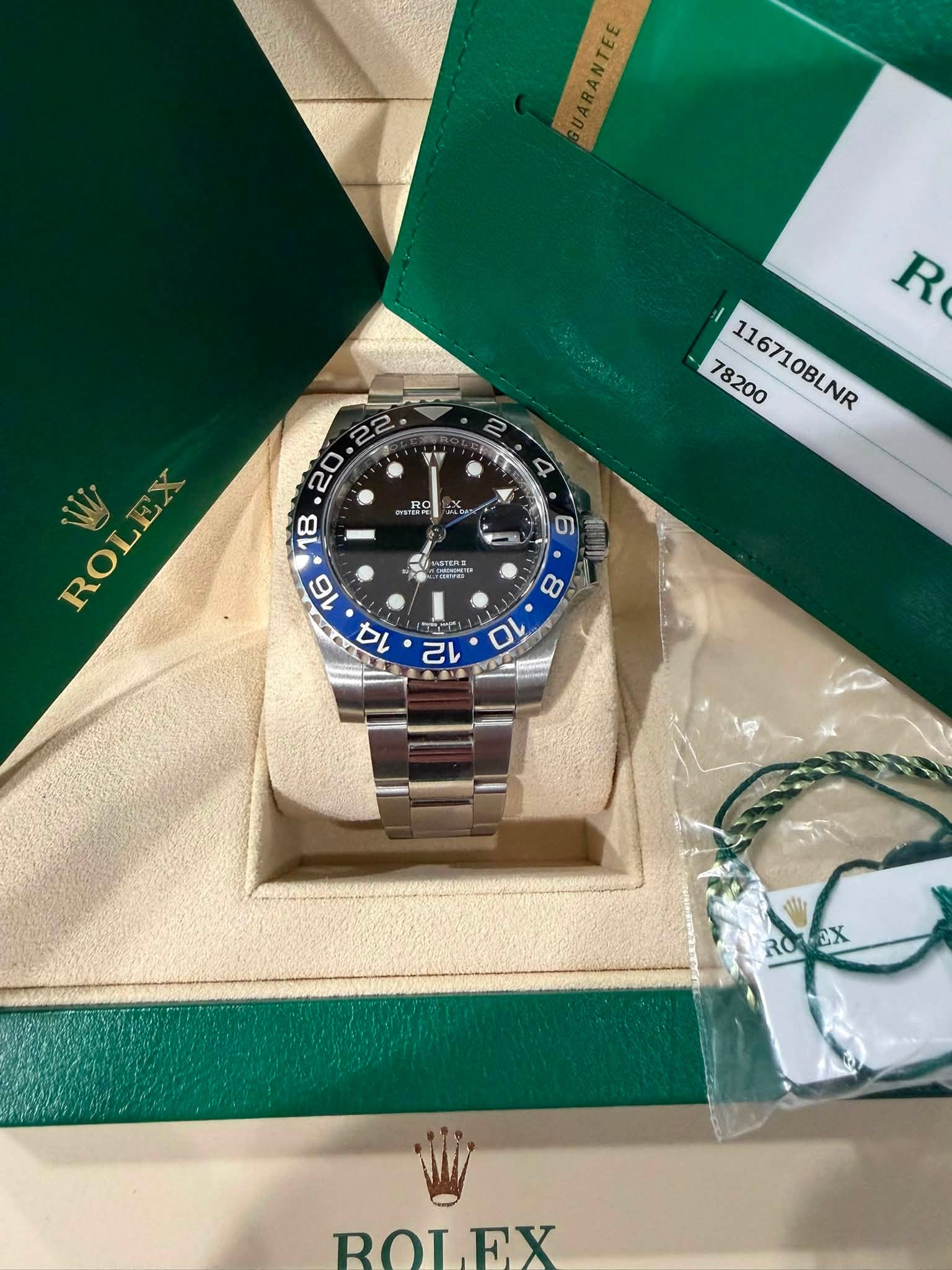 May be an image of wrist watch and text that says 'GUARANTEE 국 RANTEE Y R 78200 116710BLNR 2. 4 RO ITERE プ ROLEZ 8 10 N lle ROLEX EX ROL.P EX'