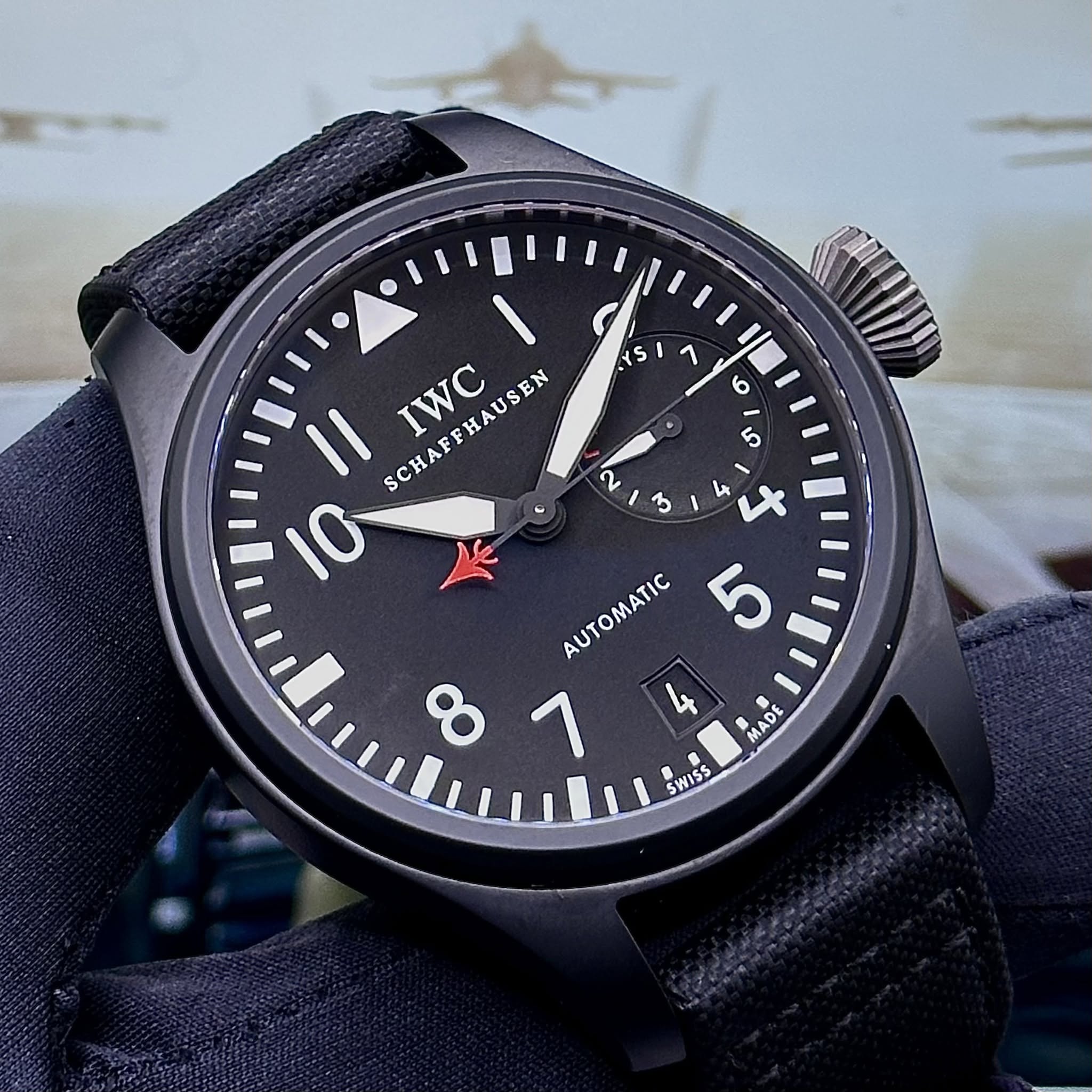 May be an image of wrist watch and text that says '٧ 45 E lO o I Il SCHAFFHAUSEN IWC 10 E x ጌ AUTOMATIC 5 7 4 MADE SWISS'