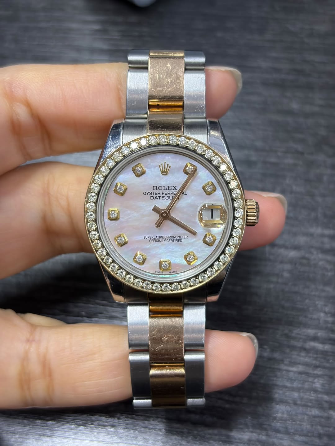 May be an image of wrist watch and text