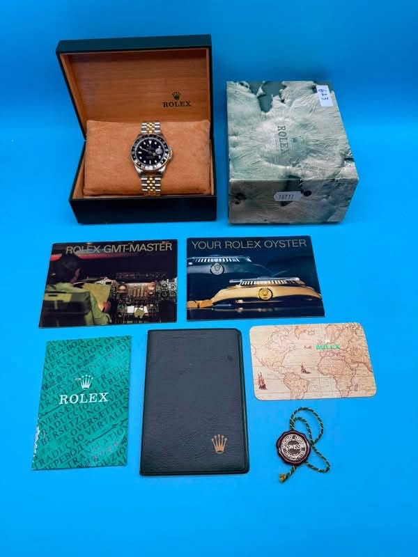 May be an image of map, leather wallet, wrist watch and text