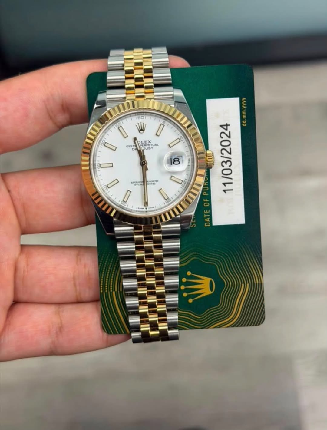 May be an image of wrist watch and text