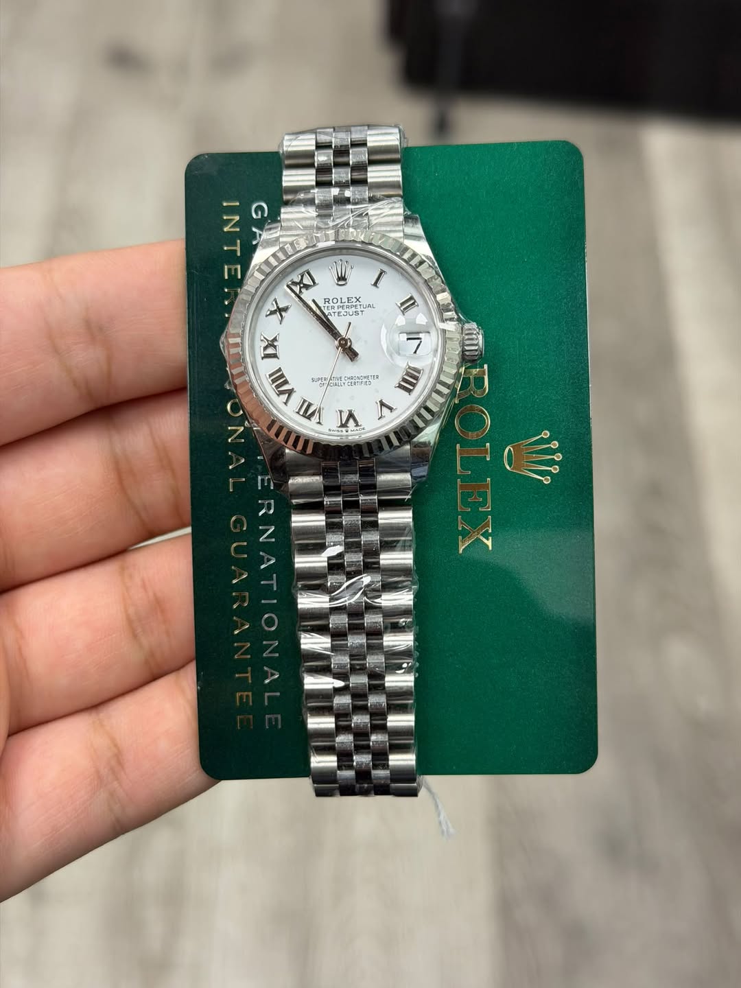 May be an image of wrist watch and text