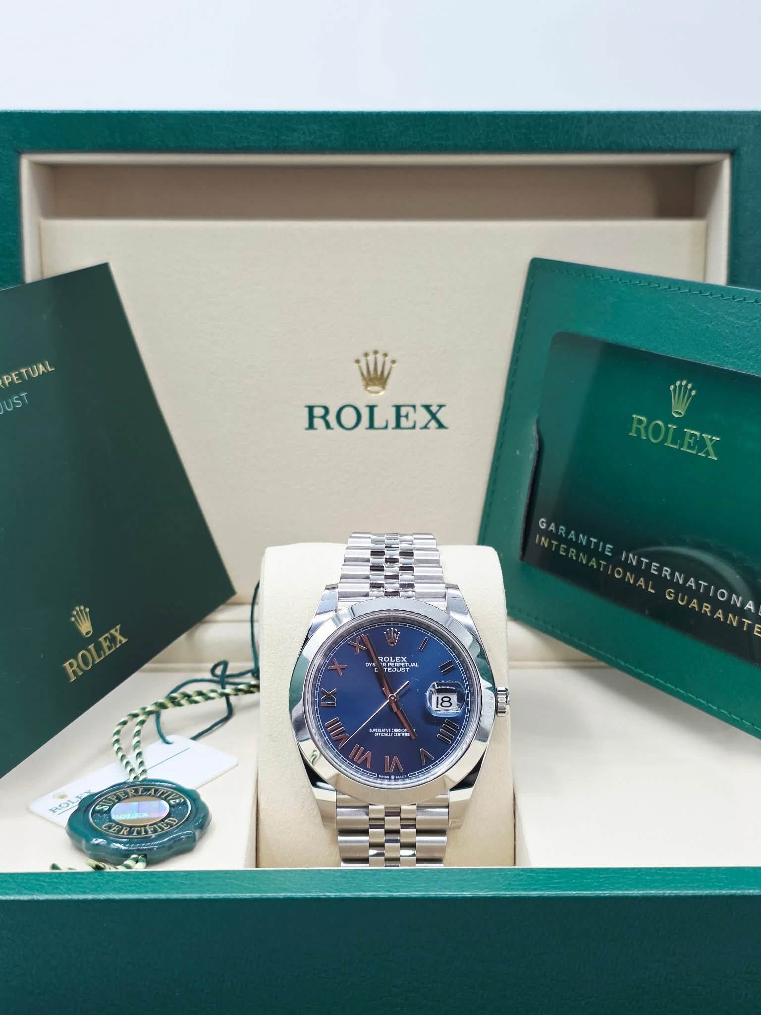 May be an image of wrist watch and text that says 'ETUAL UST ROLEX ROLEX ROLEX ROLEX ROLEX ROLEX GARANTI INTERNATIONA GUARANT GUARANT 18 ማመርባች O 1T 1 31 noL'