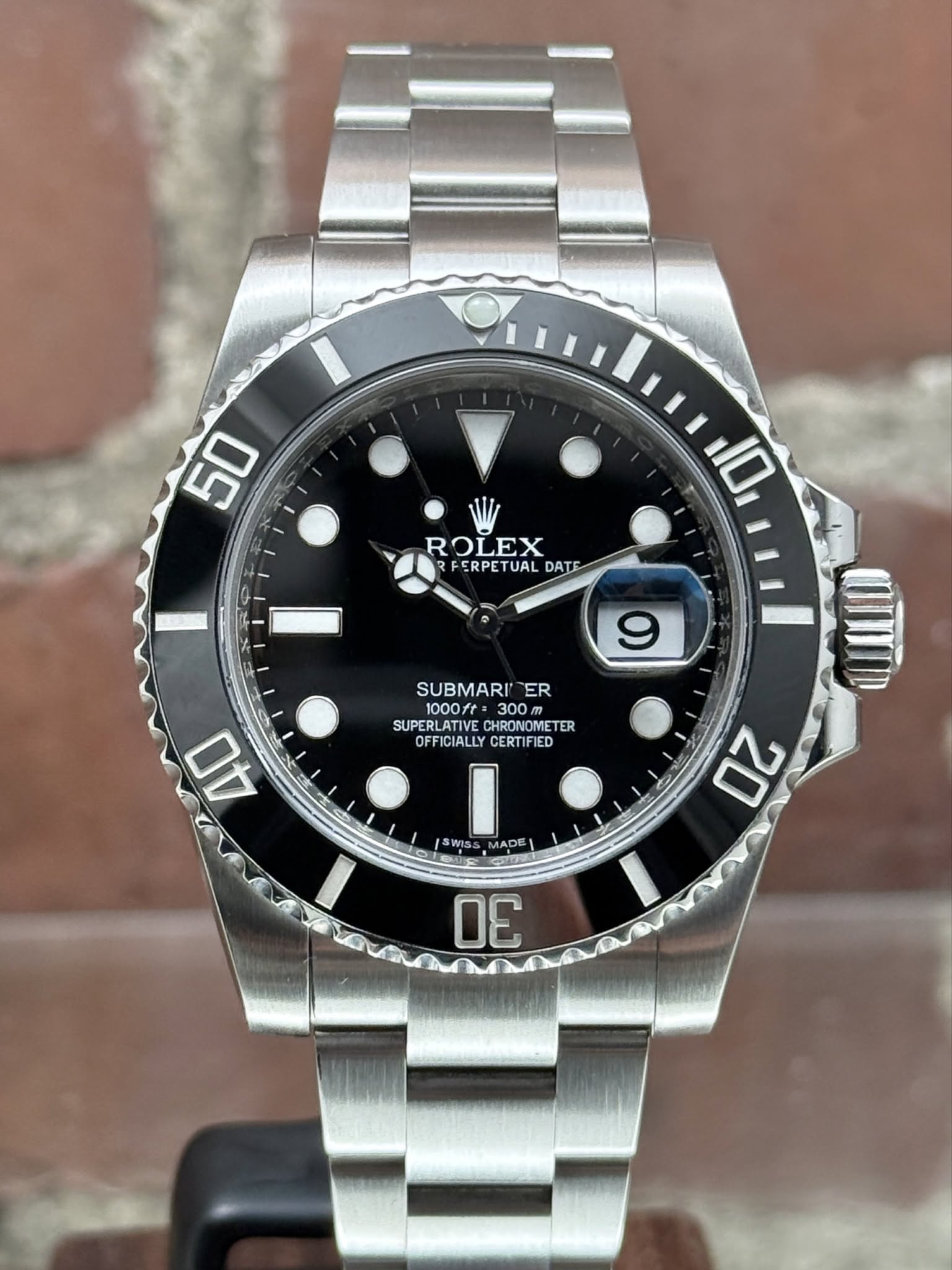 May be an image of wrist watch and text that says '50 10 ROLEX FERPETUAL DATE 9 SUBMARI SUBMARIER ER 1000ft SUPERLATIV SUPERLATIVECHRONOINETER CHRONOMETER OFFICIALLY…
