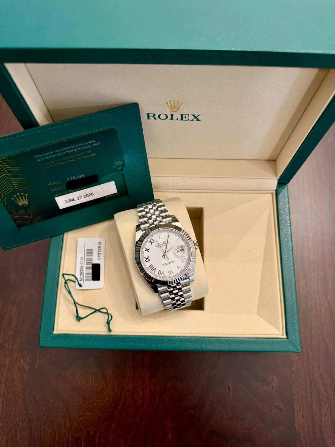 May be an image of wrist watch and text that says 'ROLEX JUNE 27 2026 mm HE 2မိ ពលិ OYSTERM M126334-0036 MU 大 5א x 4 IX ل 三 VIII u ٨ ۱لا 1'
