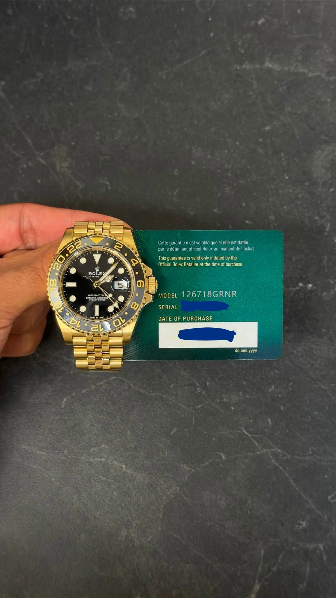 May be an image of money, wrist watch and text