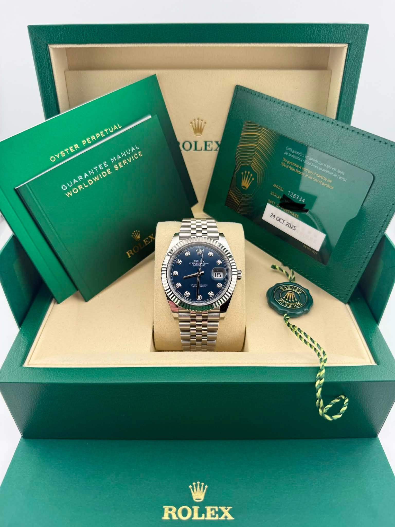 May be an image of wrist watch and text that says 'OLEX PERPETUAL OYSTER GUARANTEE OYSTERPERPETUAL MANUAL SERVICE WORLDWIDE 6aTa panchosa 26334 24OCT 2025 परल ส ท MA 5 و so 들 4…