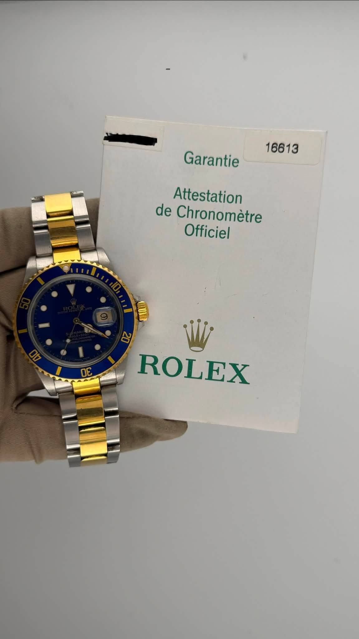 May be an image of wrist watch and text that says '16613 Garantie Attestation de Chronomètre Officiel ROLEX'