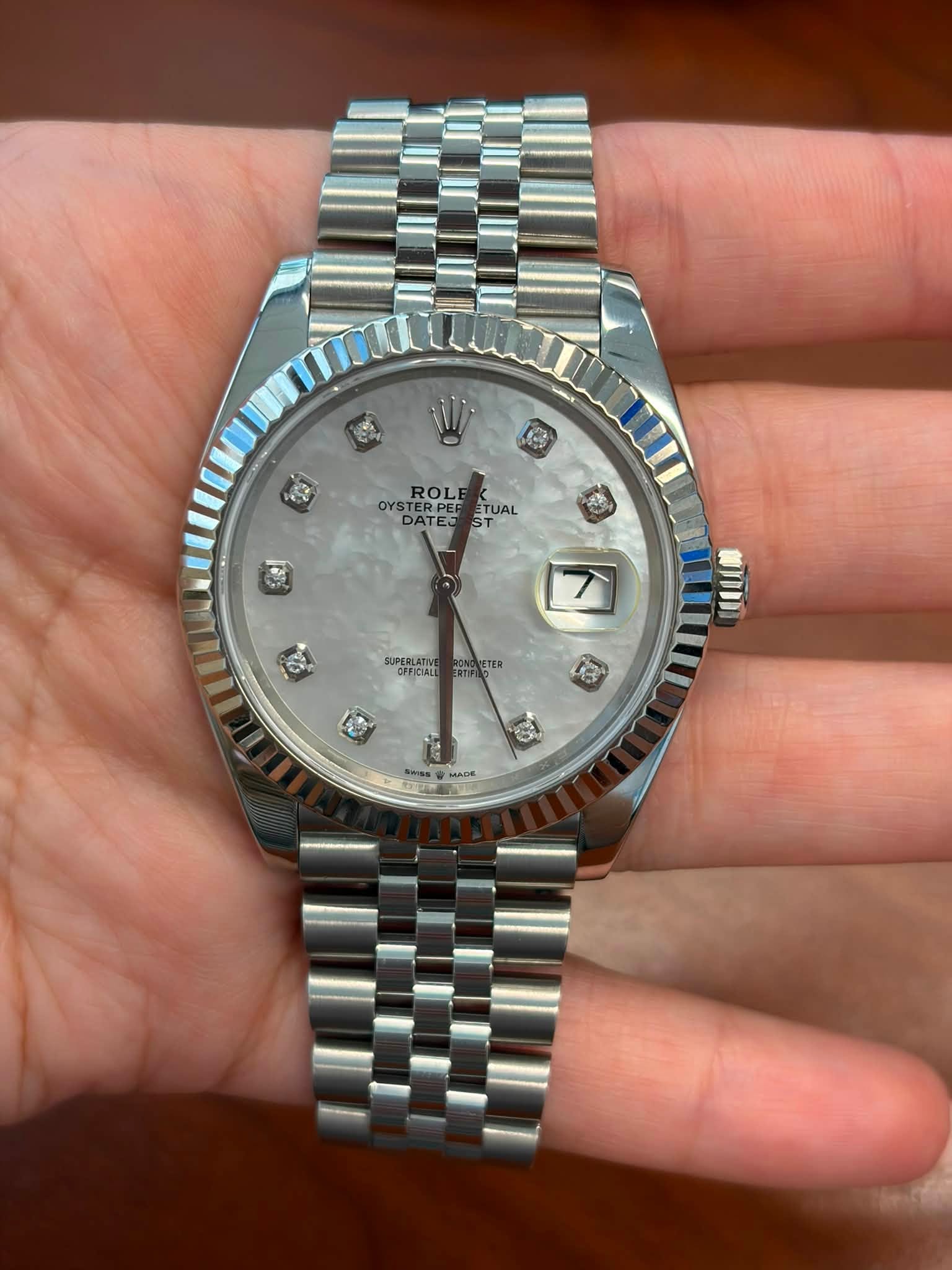 May be an image of wrist watch and text