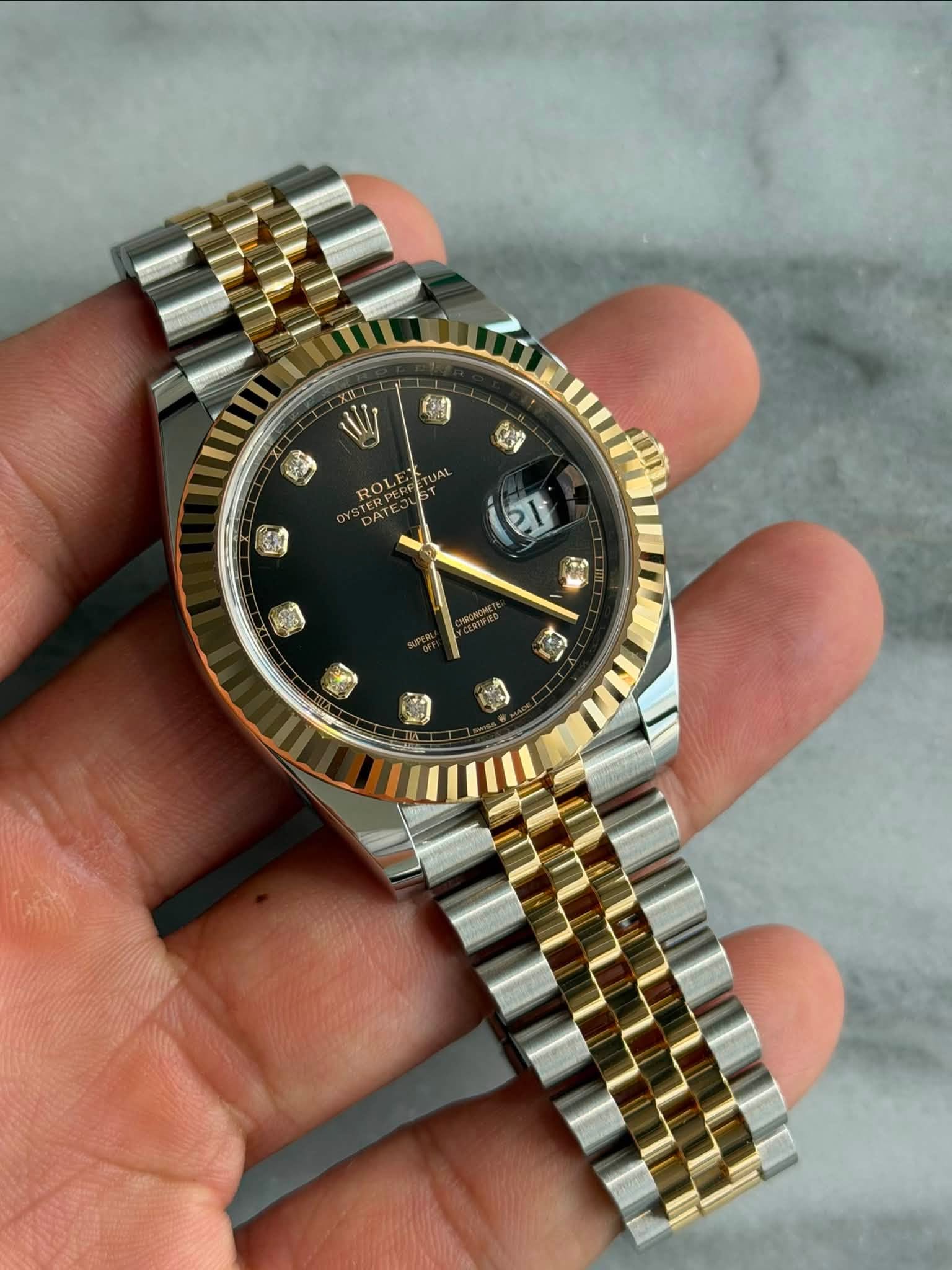May be an image of wrist watch and text